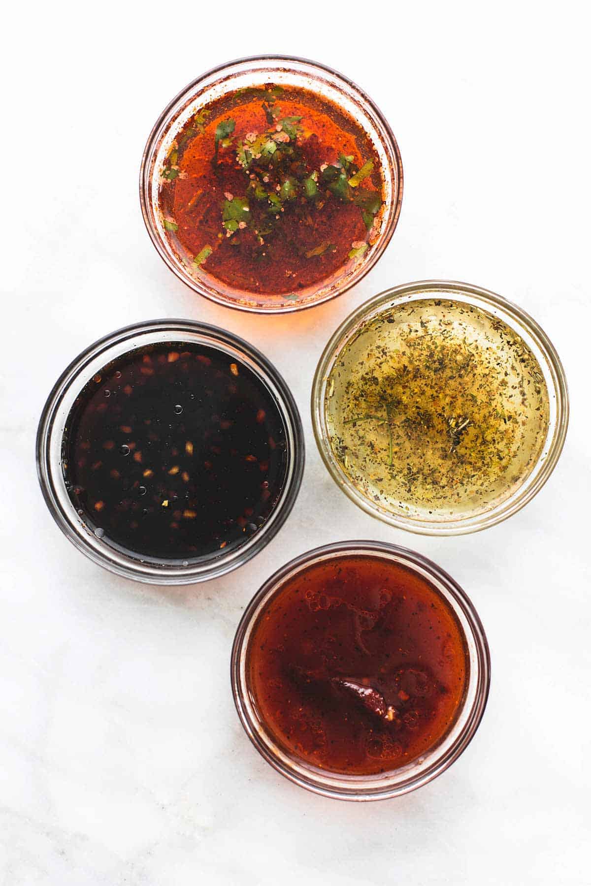 top view of 5 marinades in jars.