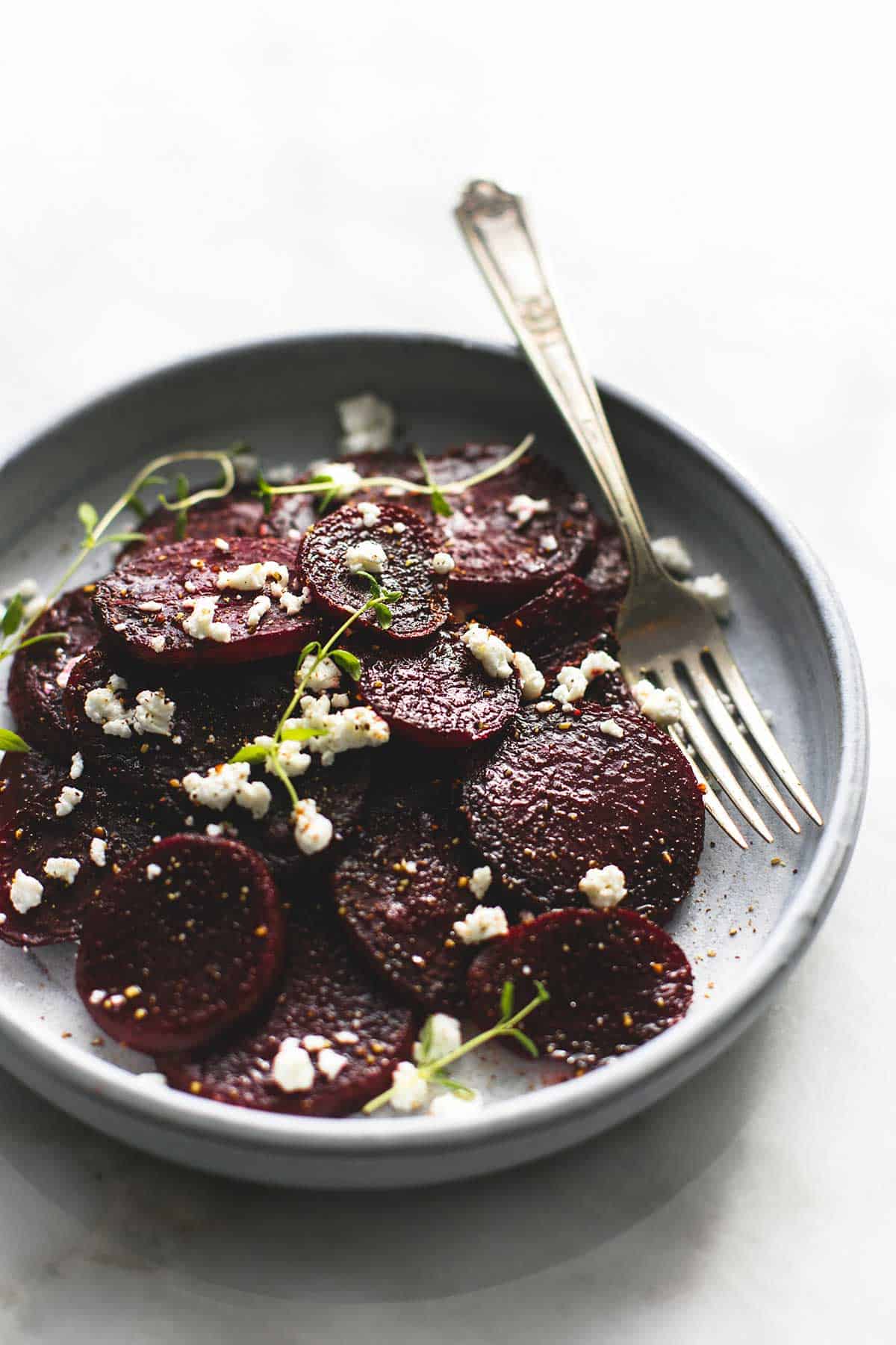 roasted beets with goat cheese with a fork on a plate.