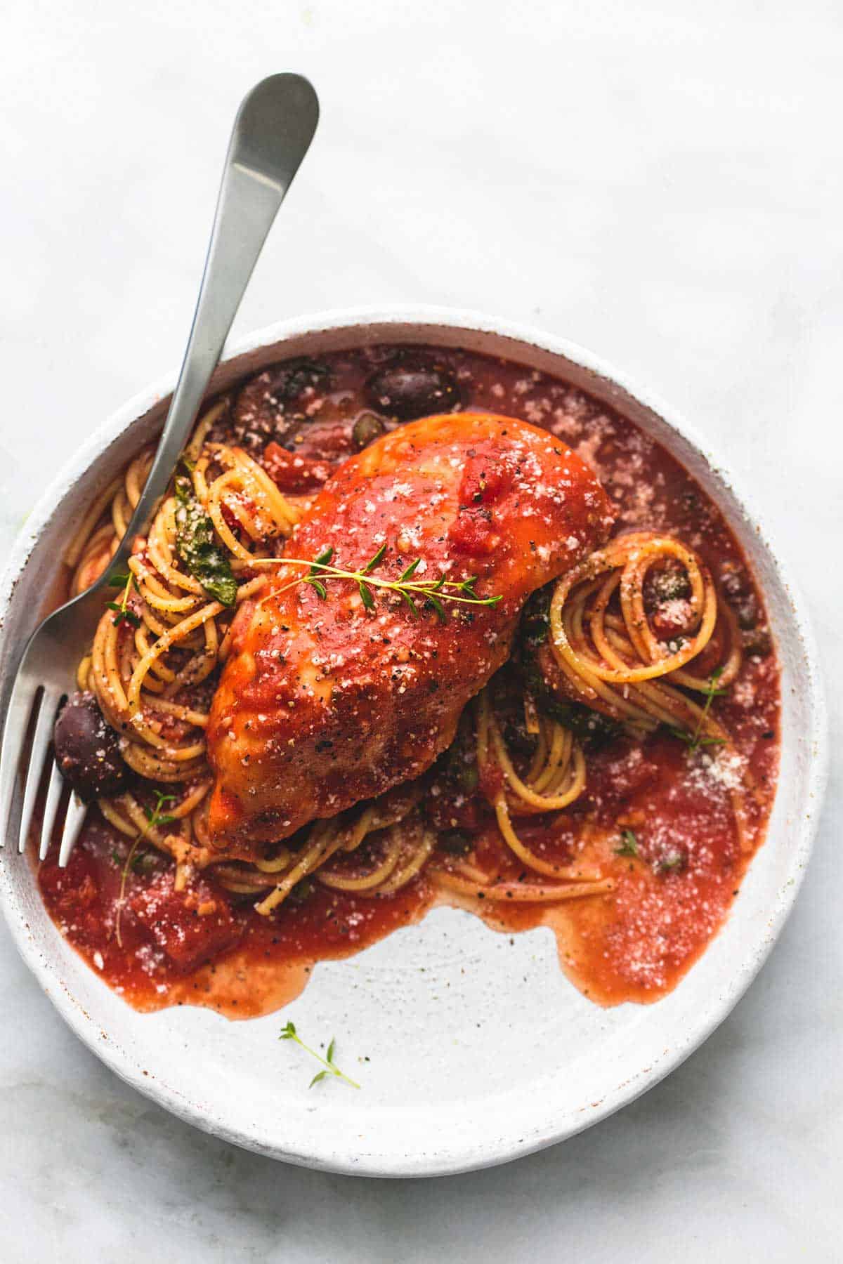 top view of slow cooker chicken cacciatore with a fork on a plate.