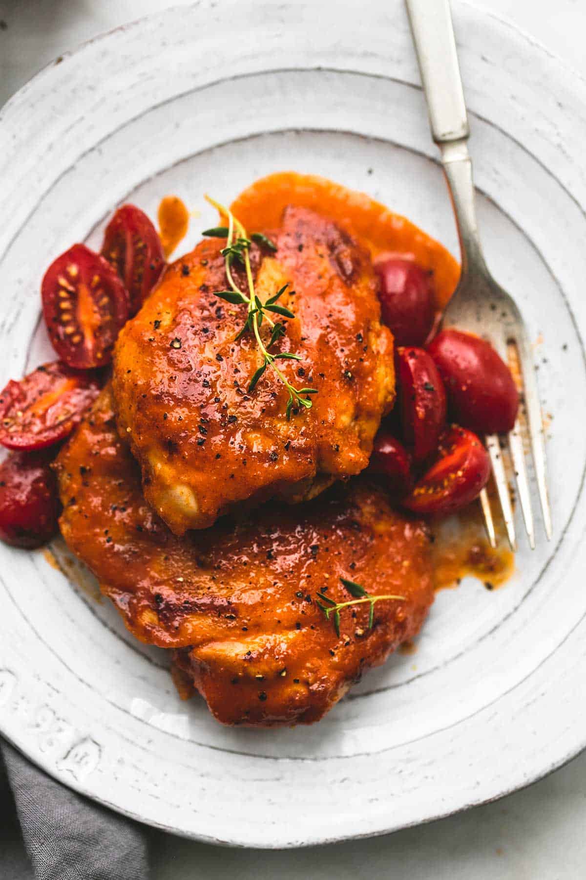 close up top view of Catalina chicken with a fork on a plate.