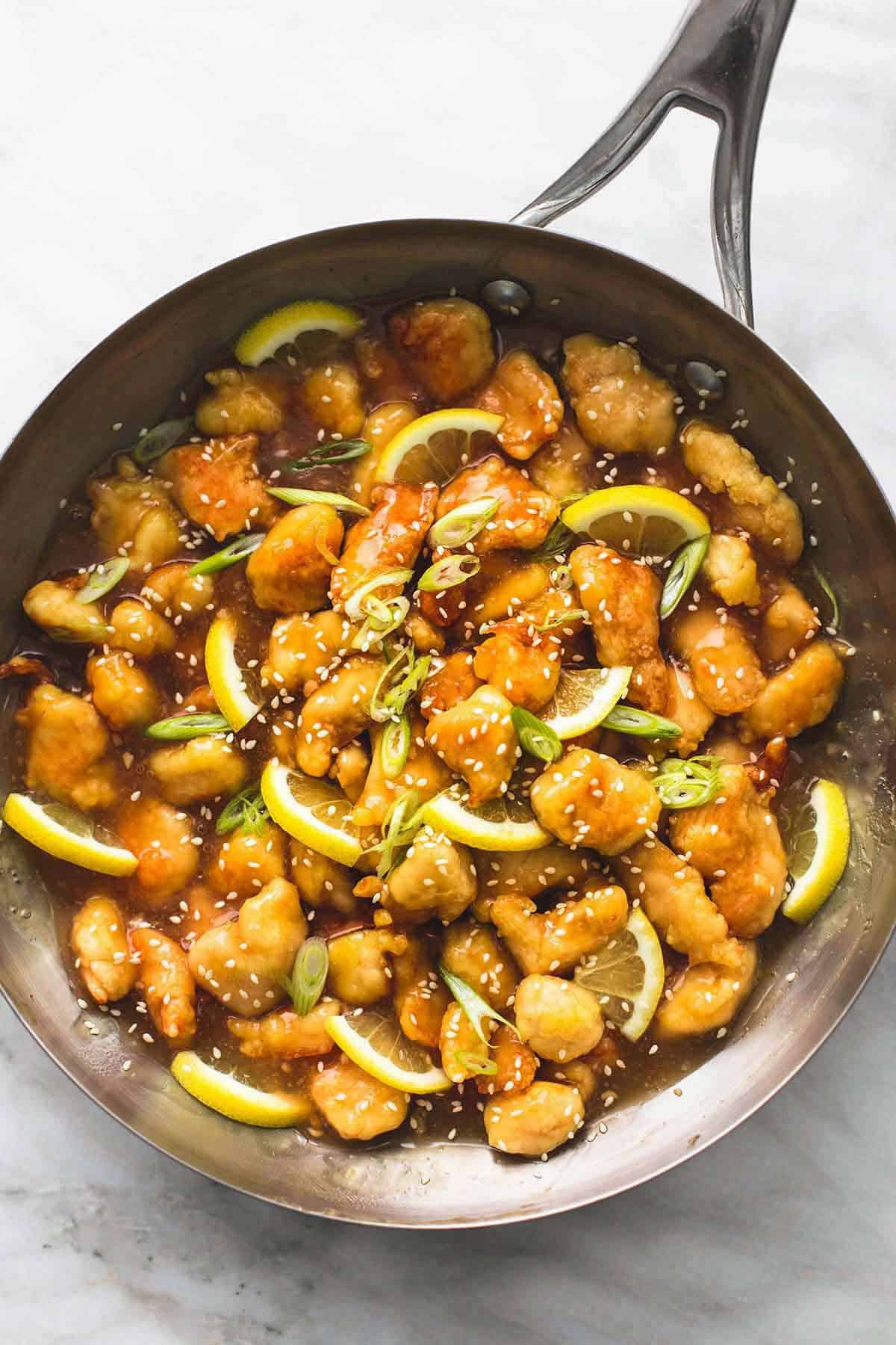 top view of sticky Chinese lemon chicken in a pan.