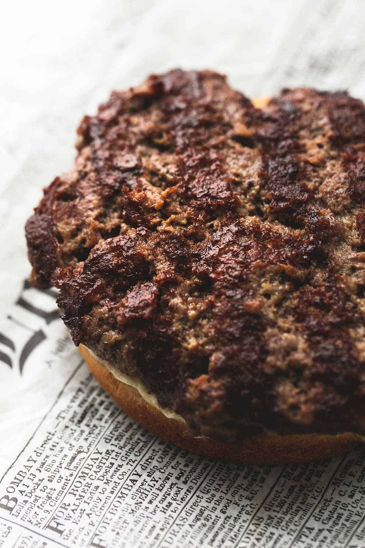 a California club burger patty on a bottom bun without toppings or the top bun.