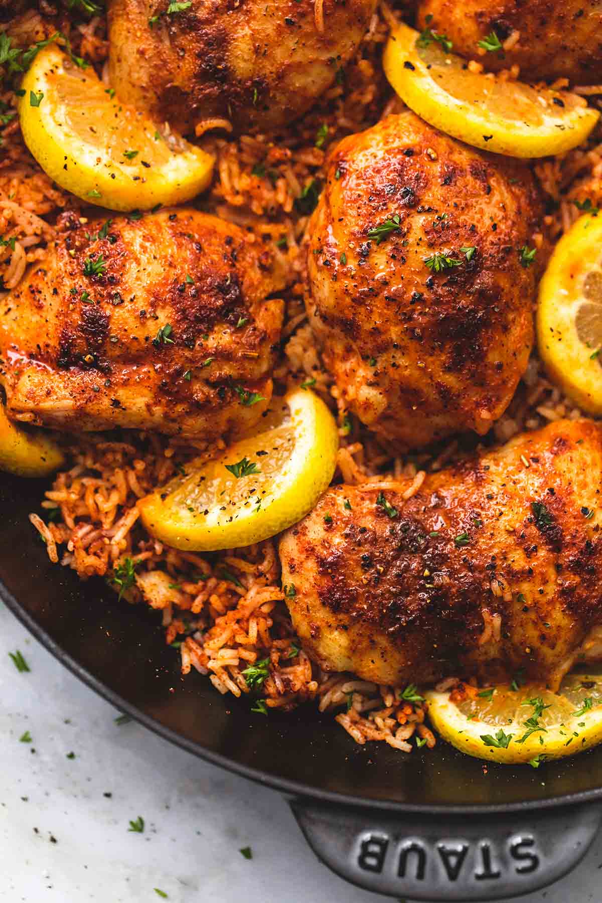 close up of Spanish chicken and rice in a pan.
