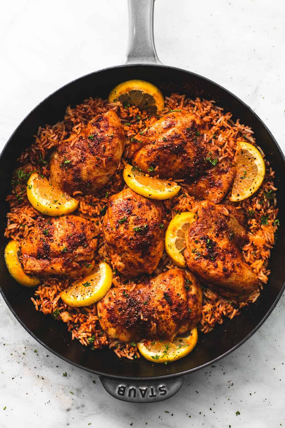 top view of Spanish chicken and rice in a pan.