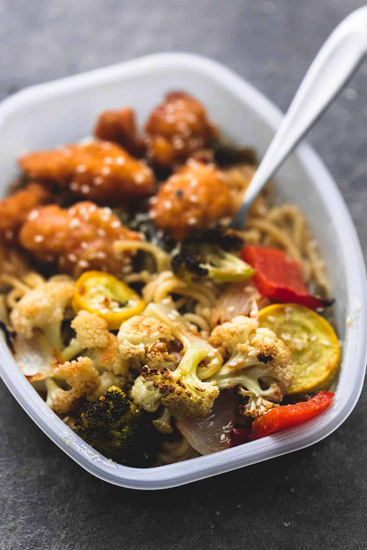 roasted Asian vegetable medley in serving tray with a fork.