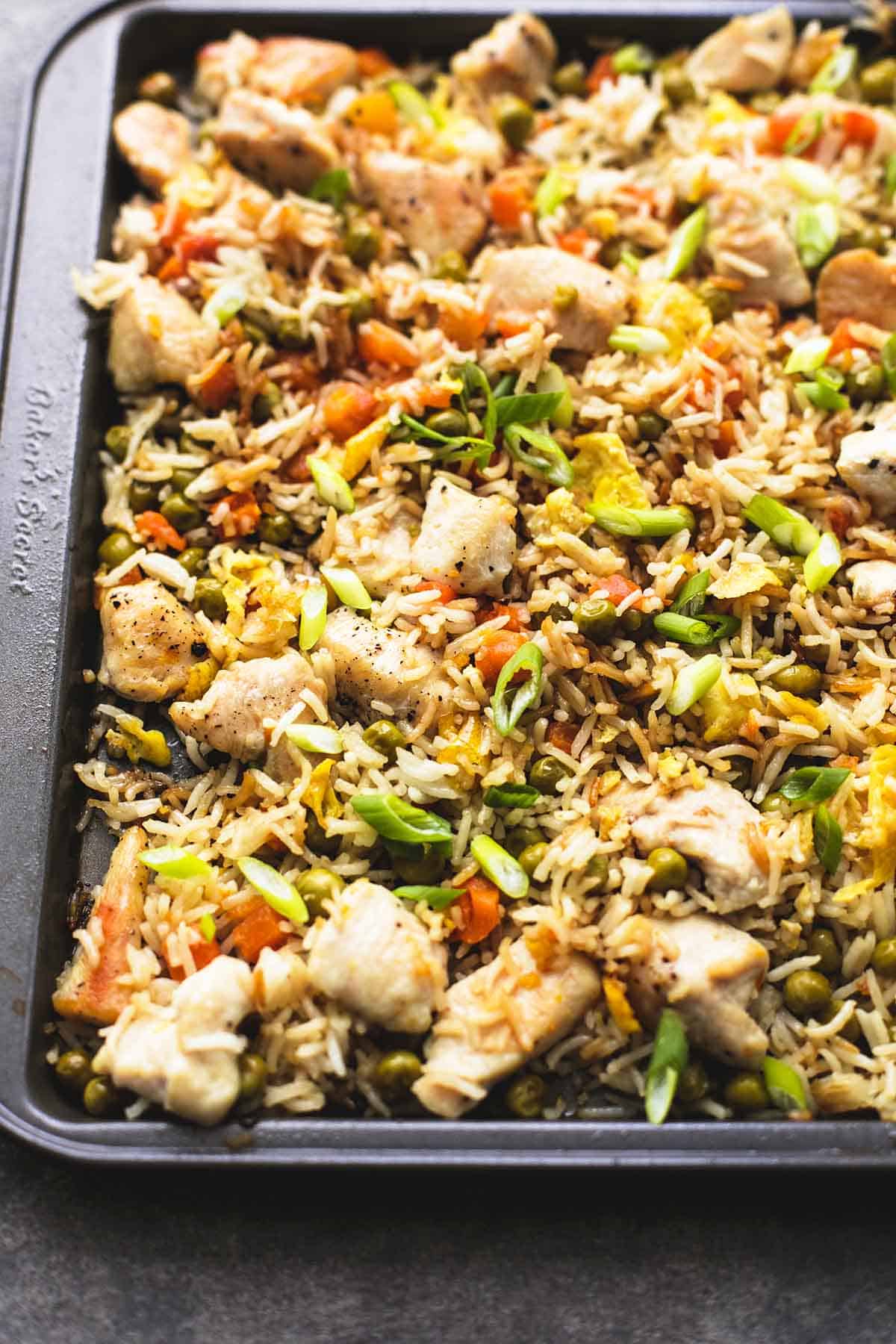 close up of sheet pan chicken fried rice in a sheet pan.