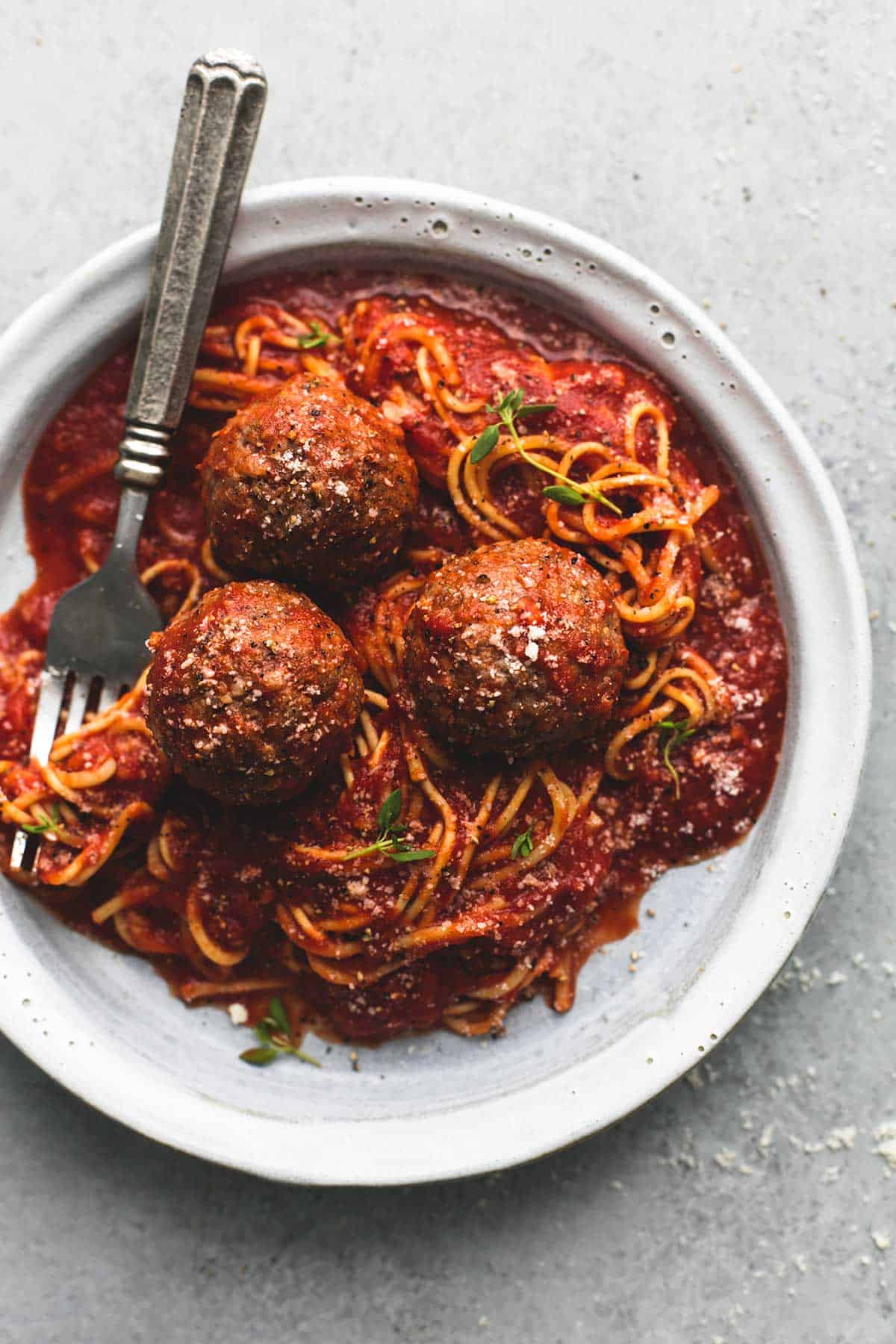 top view of slow cooker spaghetti and meatballs with a fork on a plate.