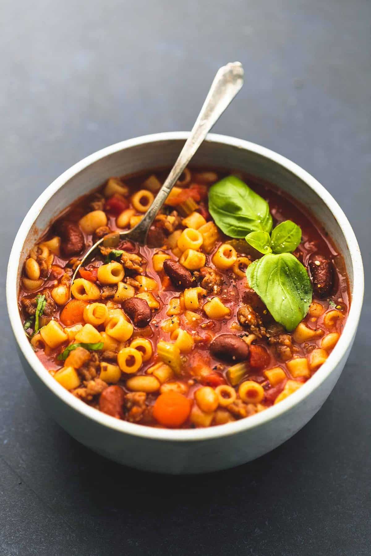 pasta e fagioli soup with a spoon in a bowl.