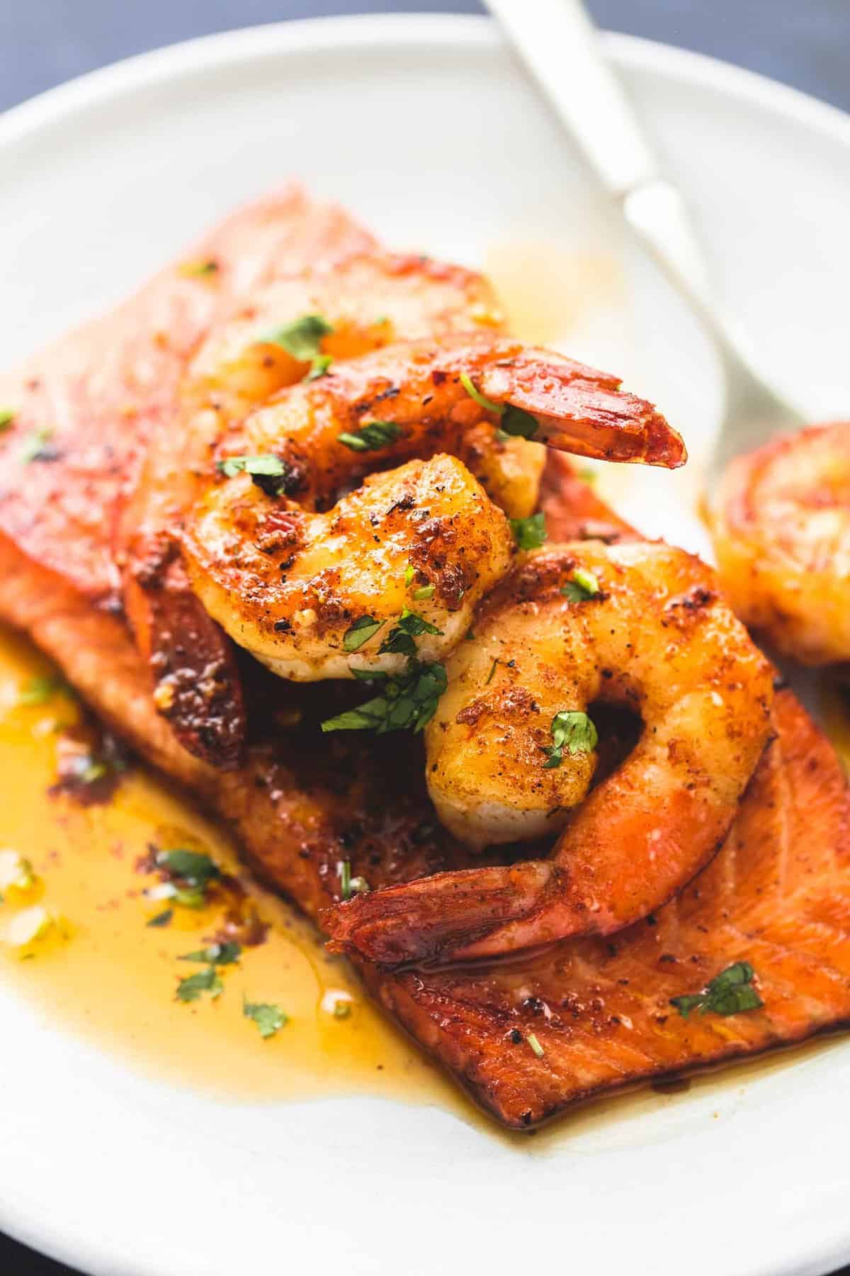 close up of salmon New Orleans with a fork on a plate.