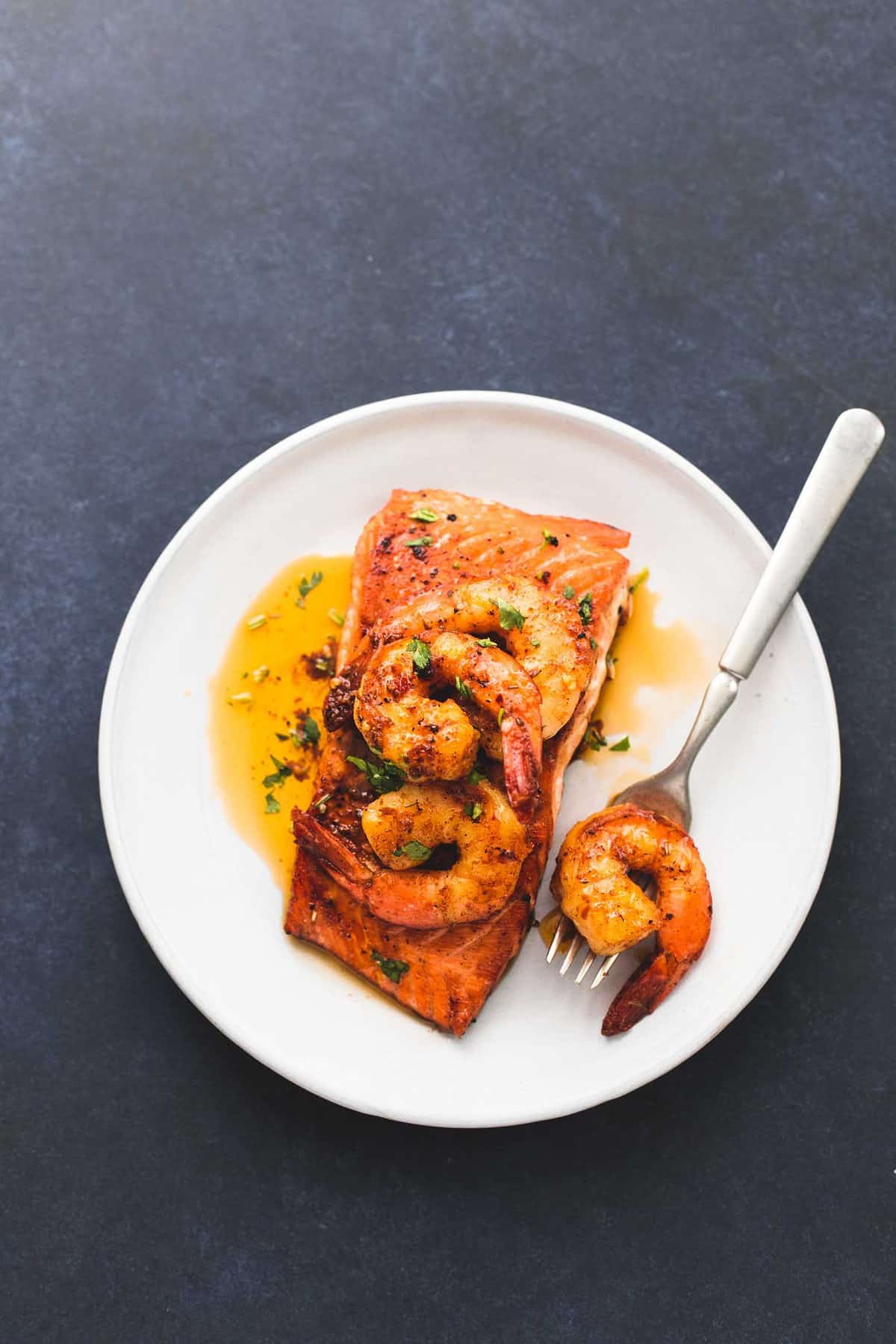 top view of salmon New Orleans with a fork on a plate.