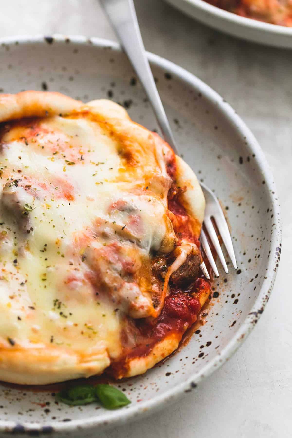 close up of pizza pot pie with a fork on a plate.