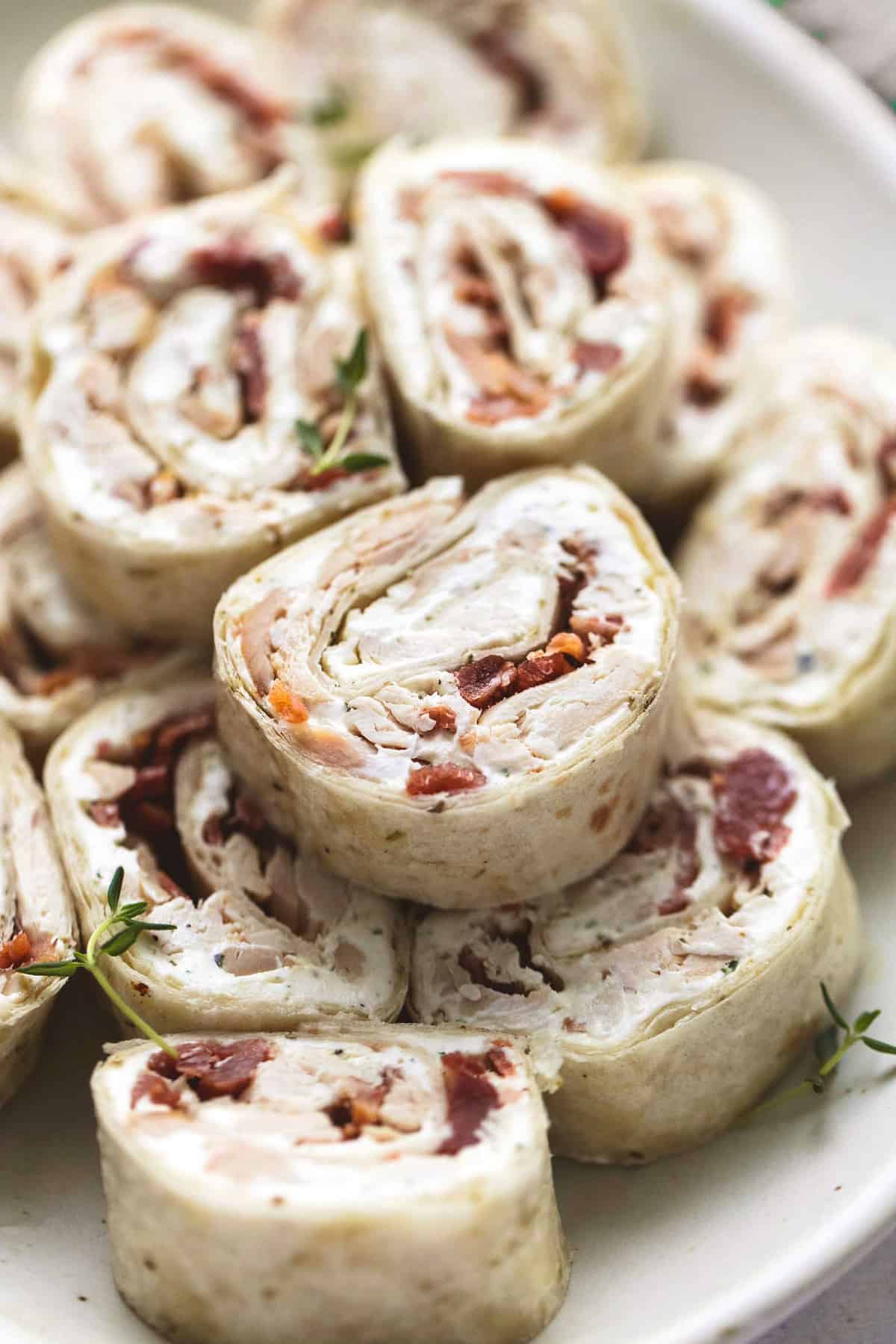 close up of chicken bacon ranch pinwheels on a plate.