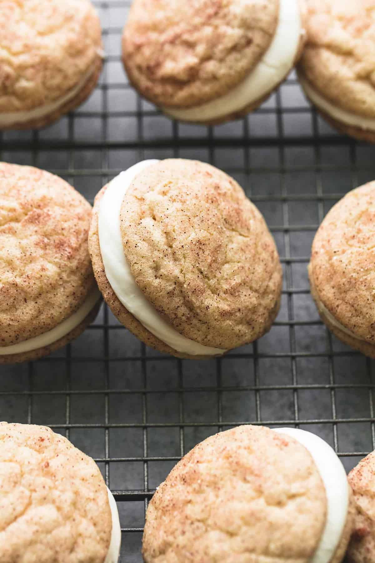 close up of eggnog snickerdoodle whoopie pies on a cooling rack.