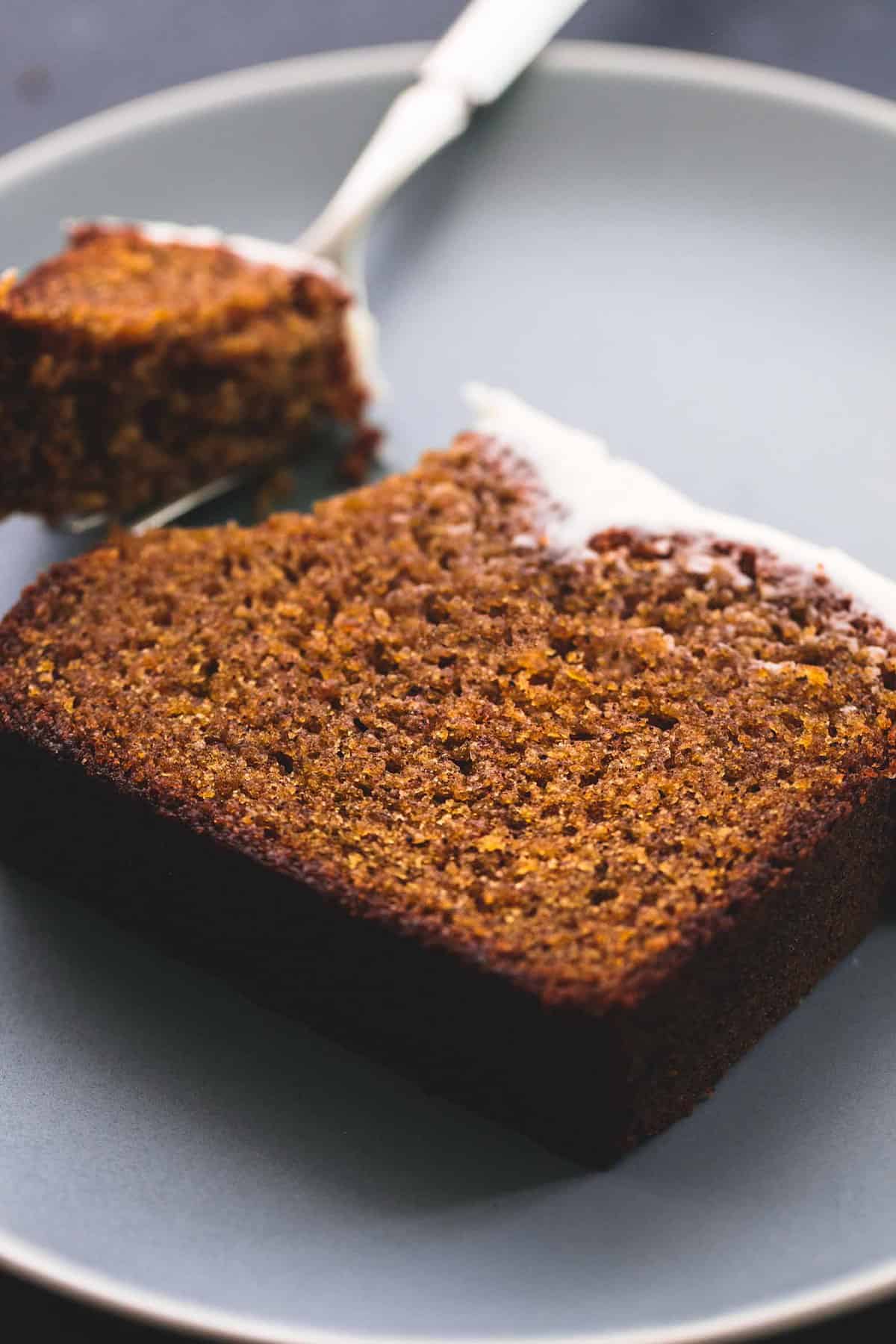 cream cheese frosted pumpkin bread slices on a cooling rack.