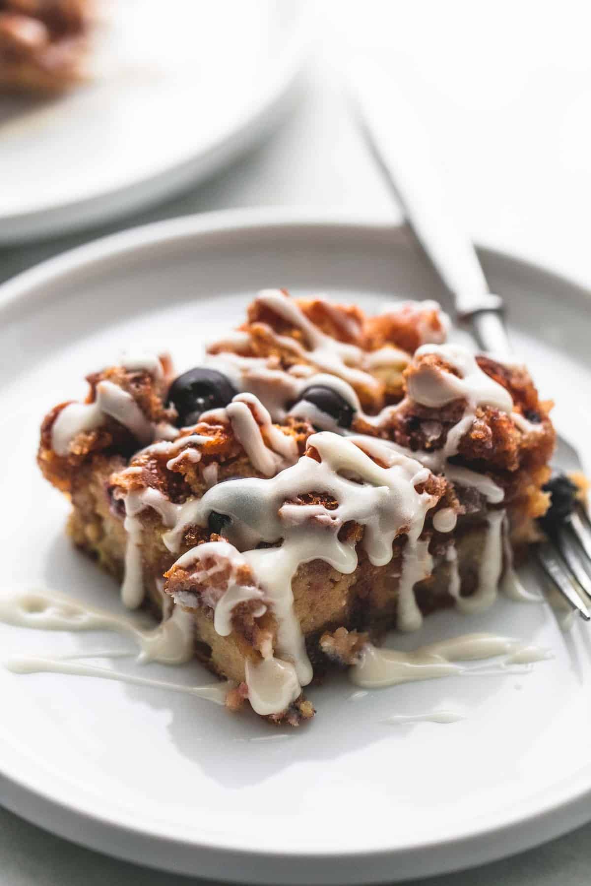 a piece of blueberry donut French toast bake with a fork on a plate.