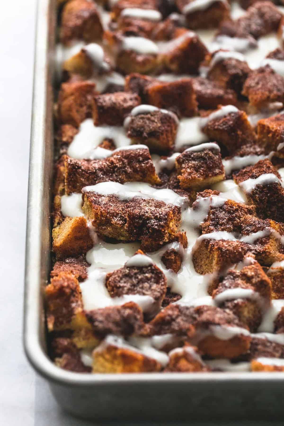 close up of overnight cinnamon roll French toast casserole in a baking sheet.
