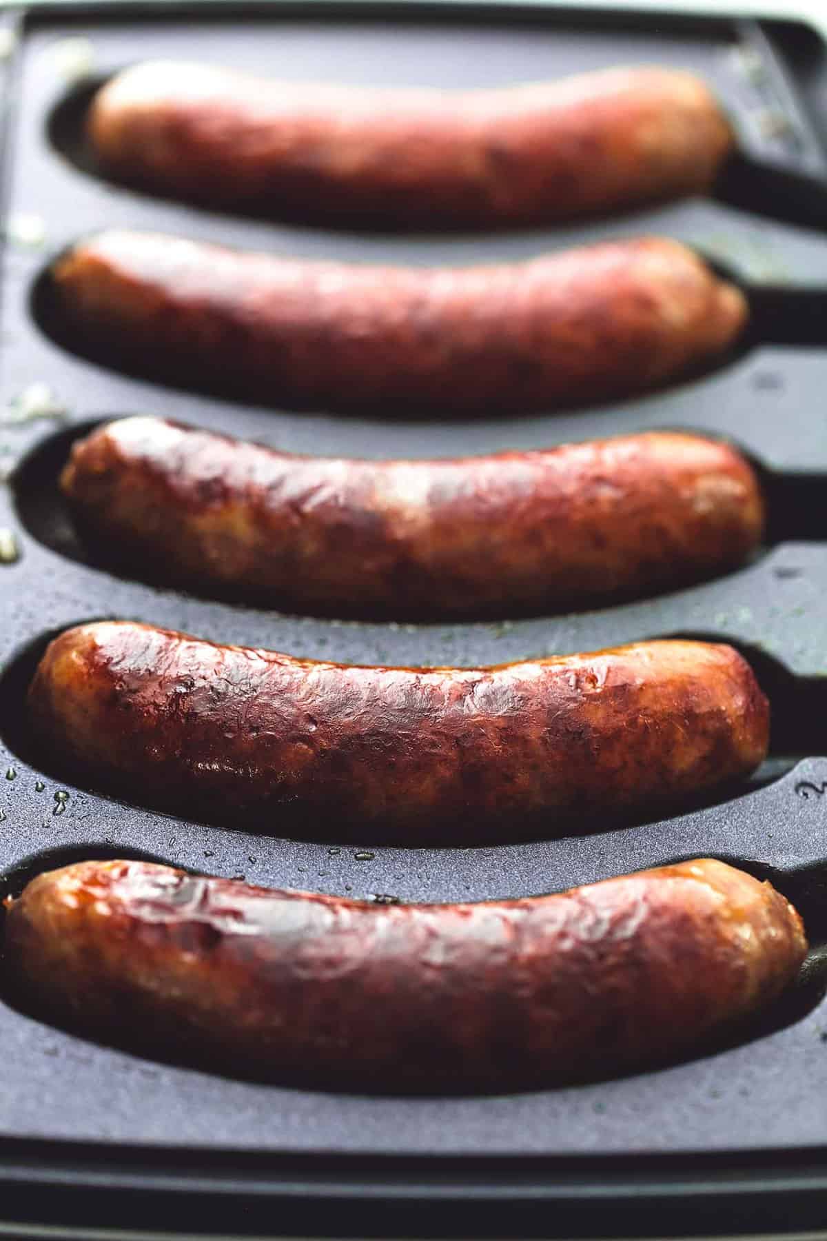 close up of sausages in a grill.