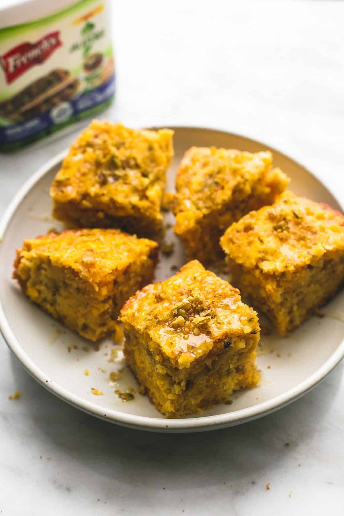 slow cooker honey jalapeño cornbread on a plate with a container of French's crispy jalapeños faded in the background.