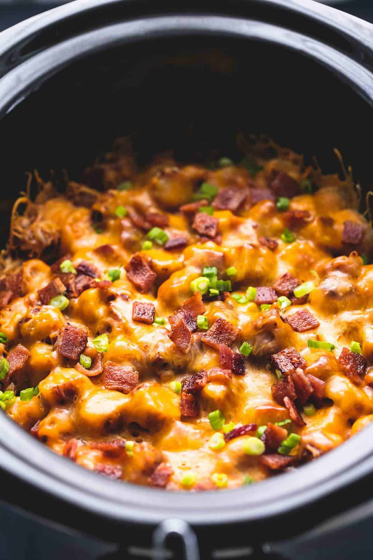 close up of slow cooker loaded tater tot breakfast casserole in a slow cooker.