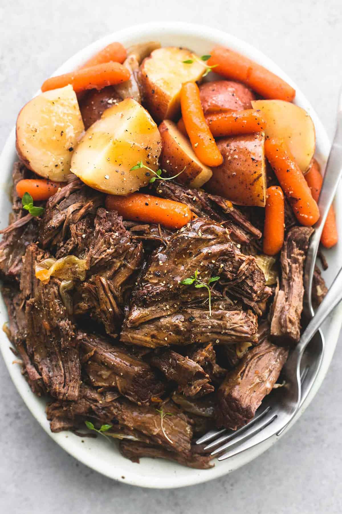 instant pot pot roast and potatoes with a fork on a plate.