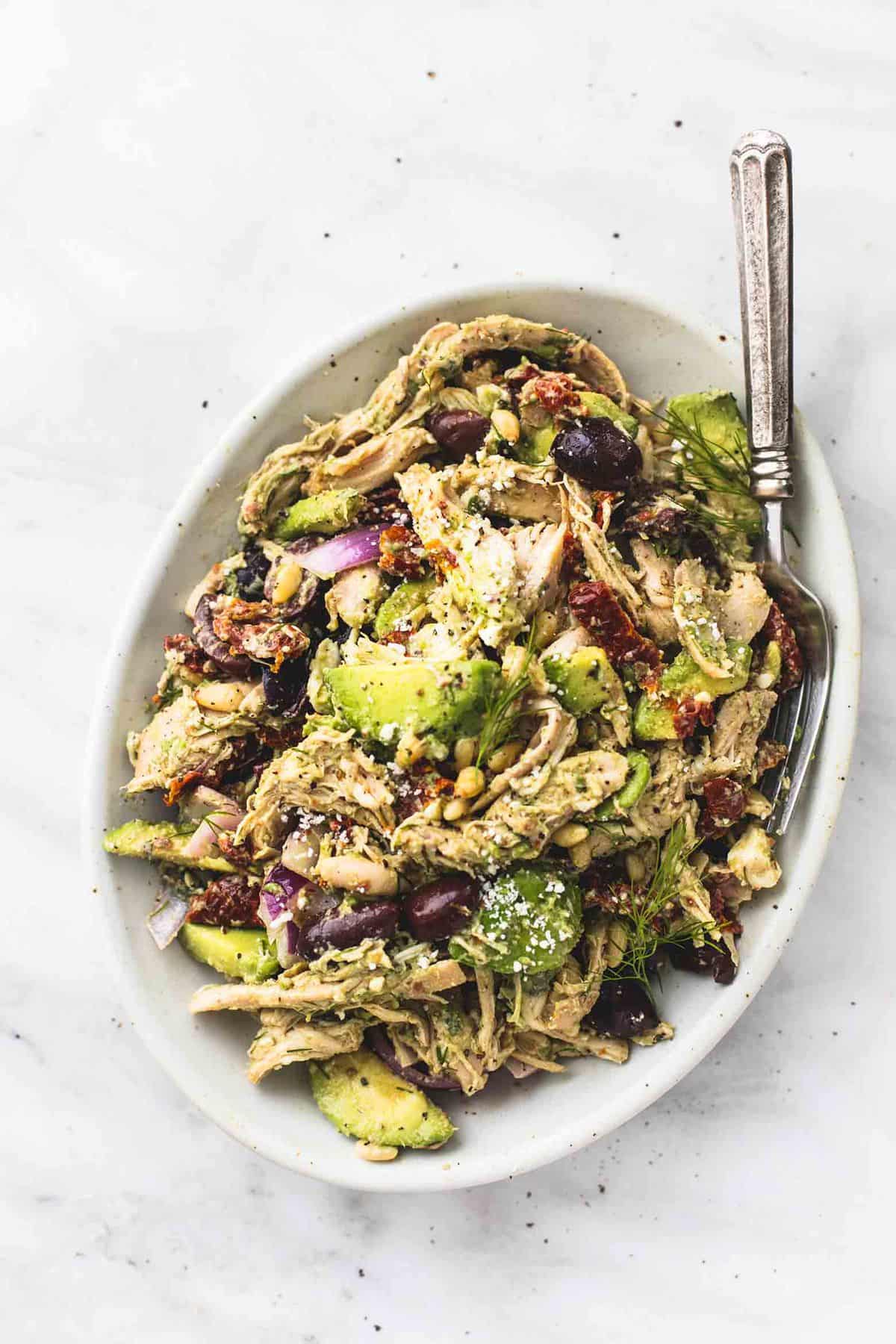 top view of Greek avocado chicken salad with a fork on a platter.