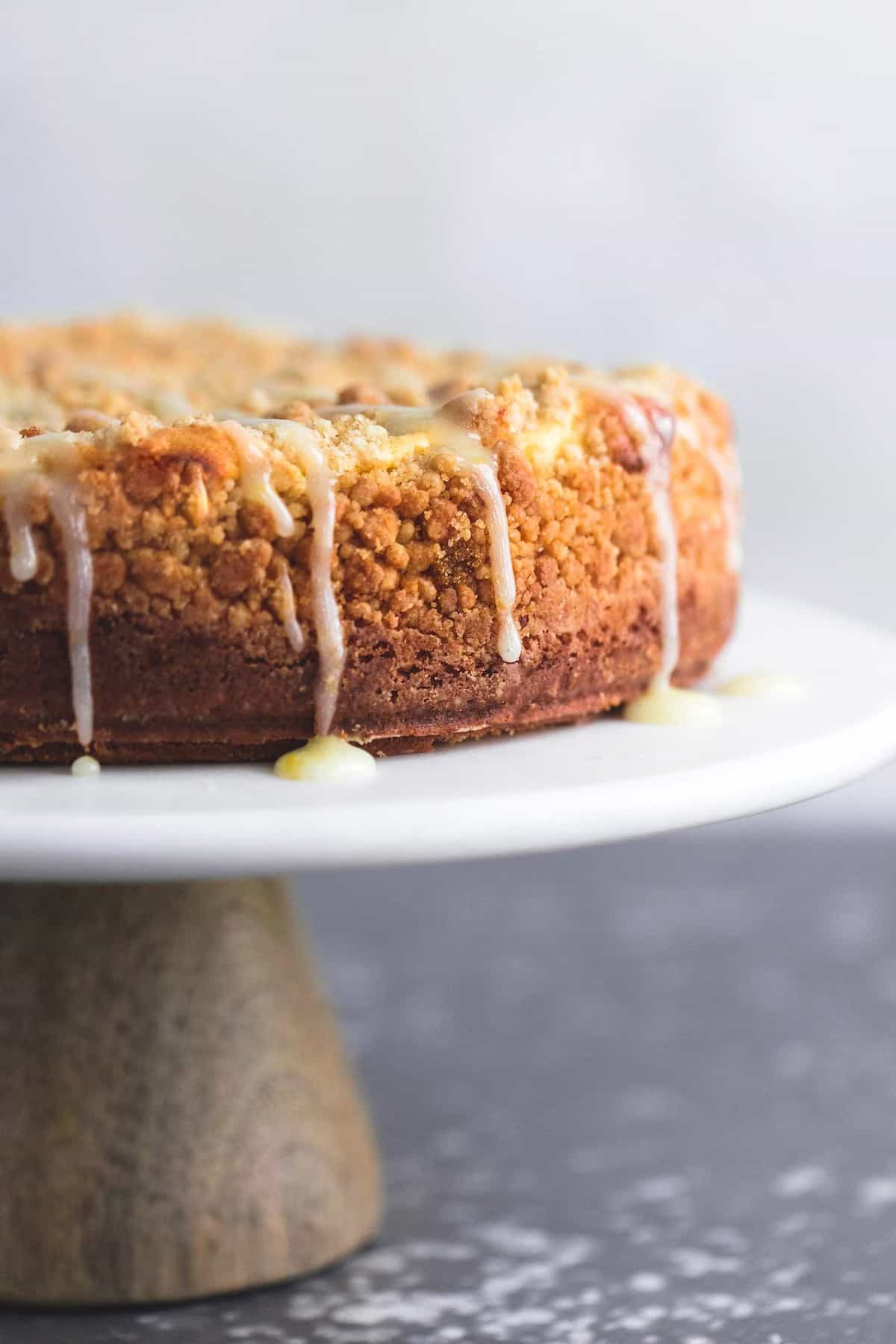 cream cheese lemon crumb cake on a cake stand. 