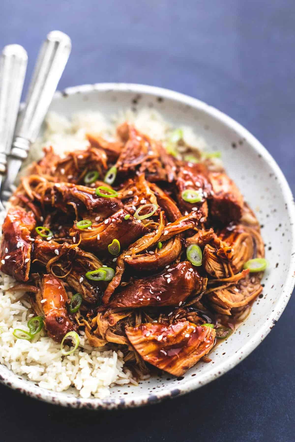 instant pot honey teriyaki chicken with rice and forks on a plate.