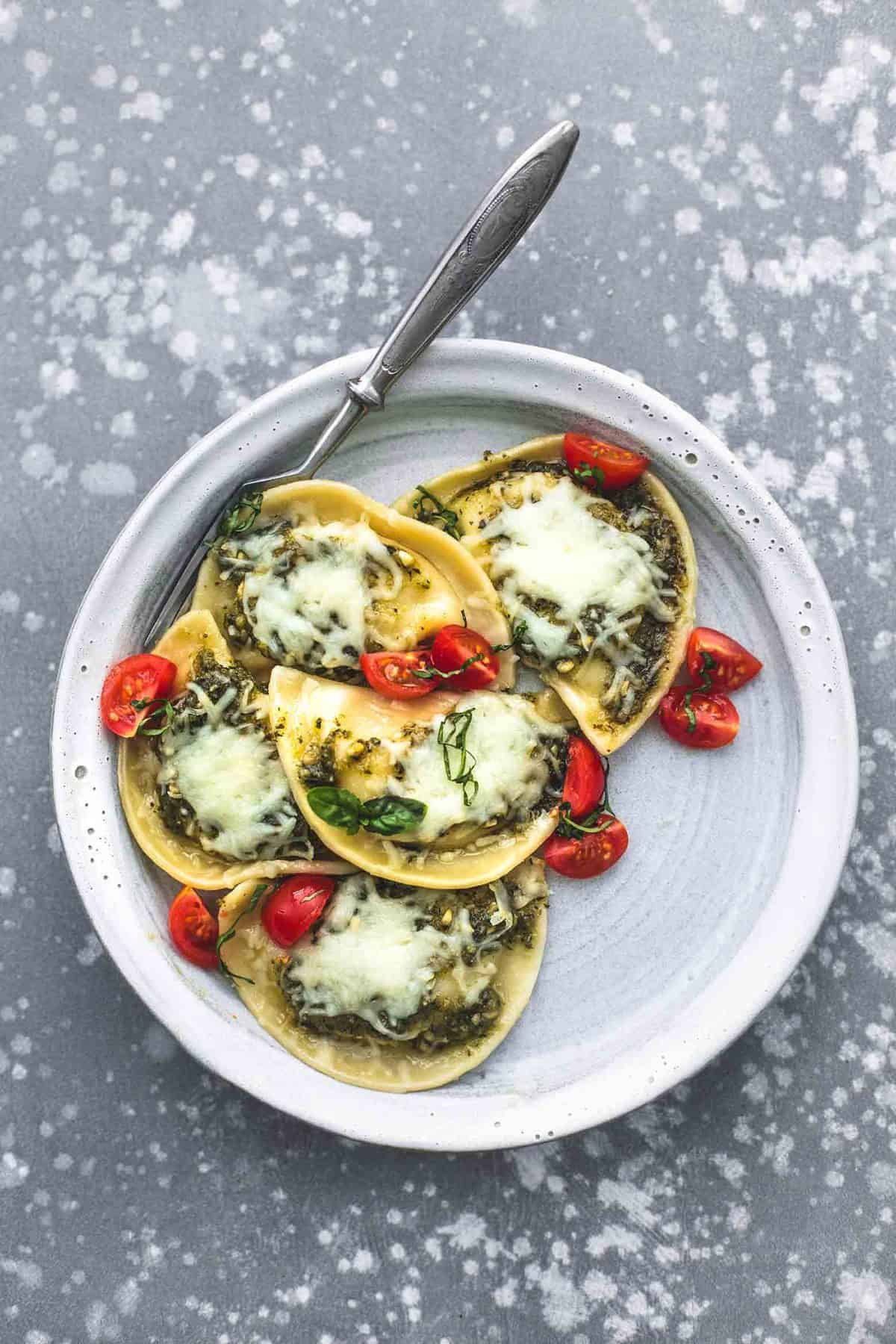 top view of margherita pierogies skillet with a fork on a plate.