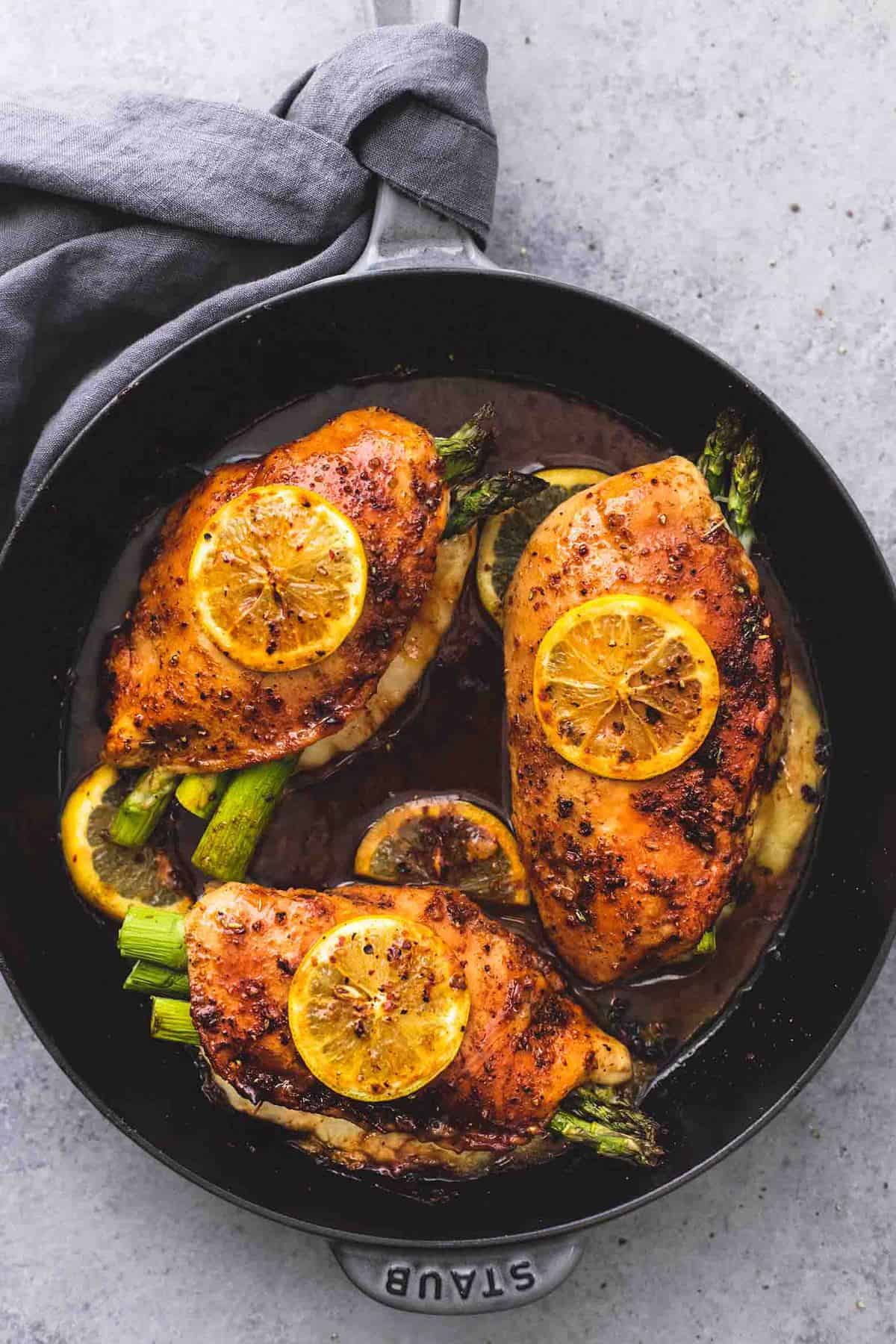 top view of asparagus stuffed chicken in a pan.