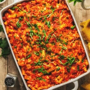 Overhead close up of baked ziti with sausage in a casserole dish.