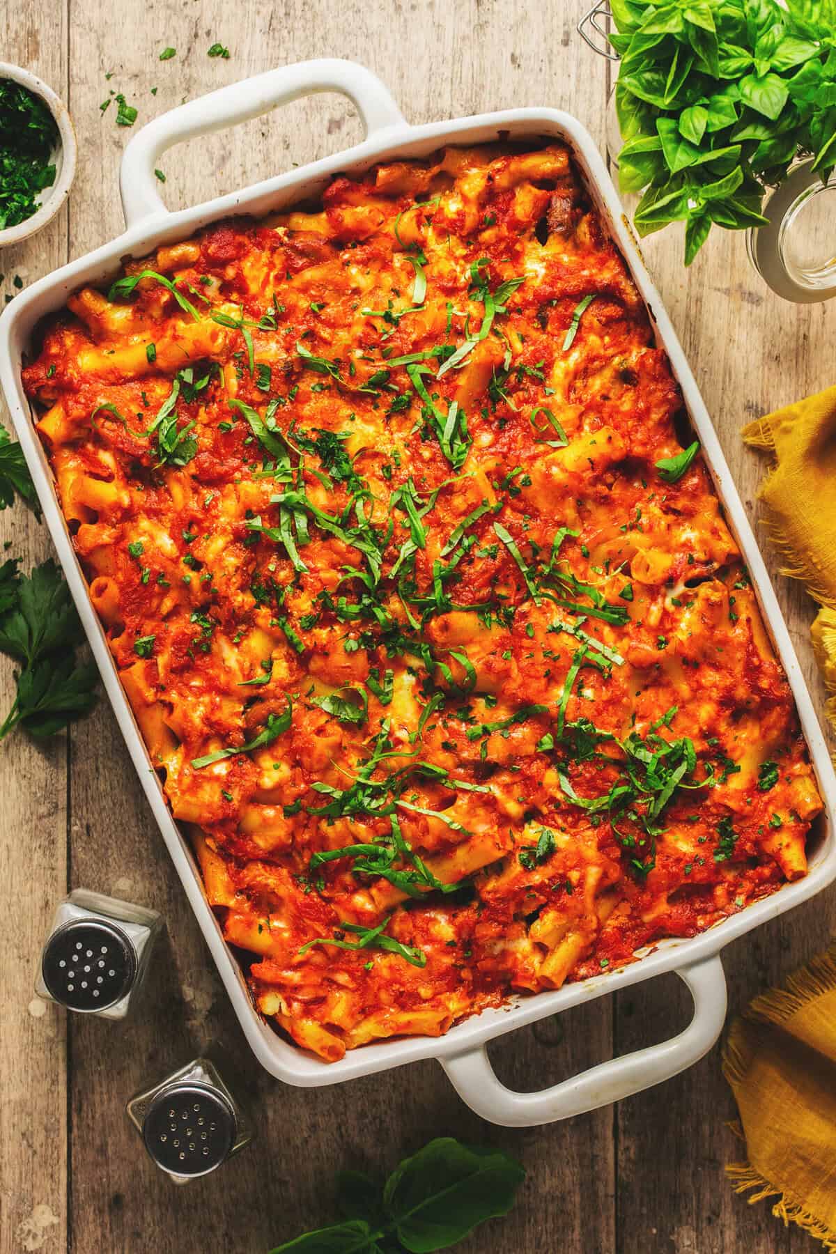 Overhead close up of baked ziti with sausage in a casserole dish.
