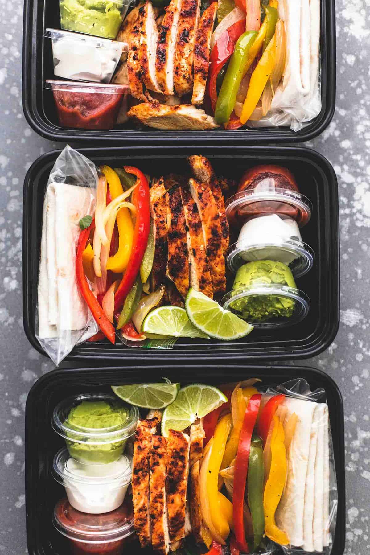 top view of meal prep chicken fajitas in tupperware containers in a vertical line.