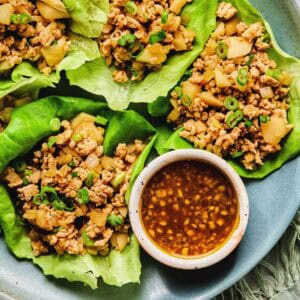 Close up of Asian chicken lettuce wraps on a plate.