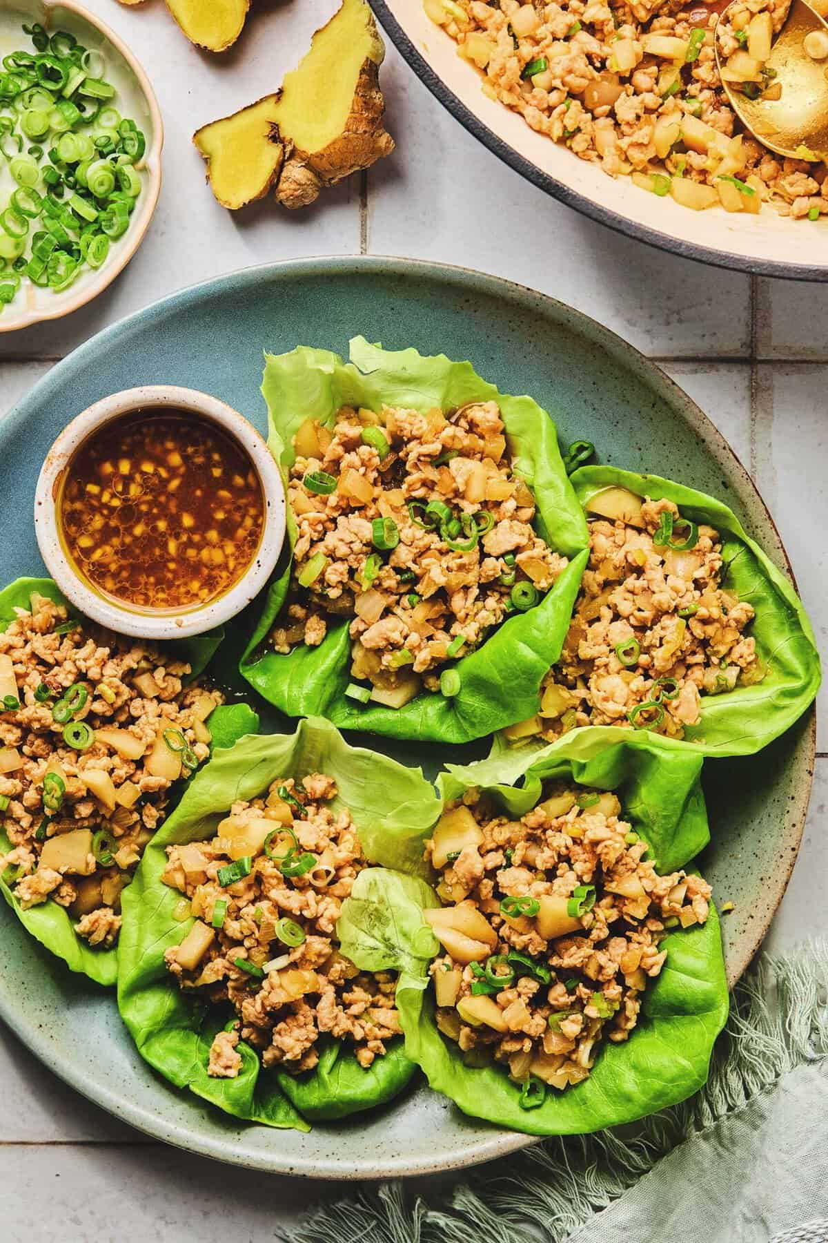 Overhead of Asian chicken lettuce wraps on a plate.