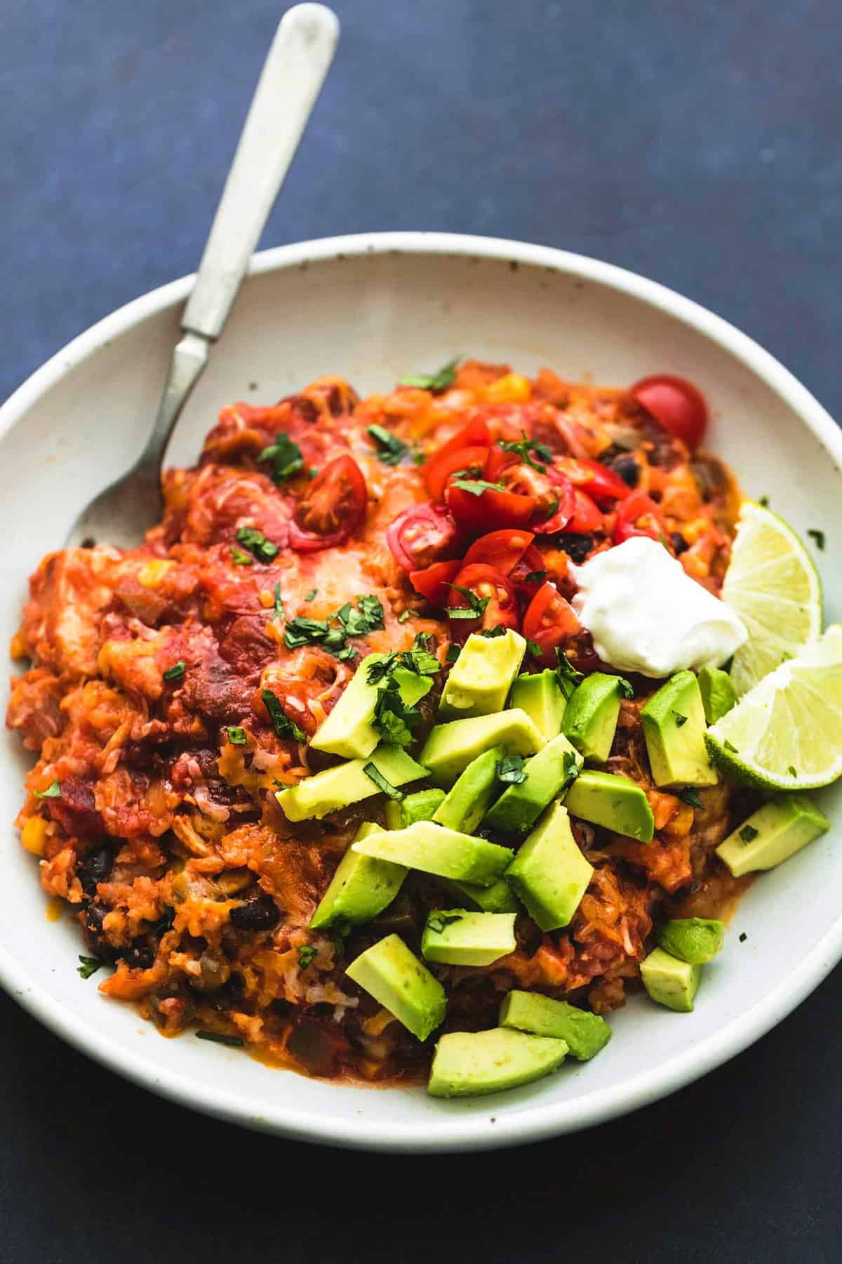 instant pot cheesy Mexican chicken and rice with a fork in a bowl.