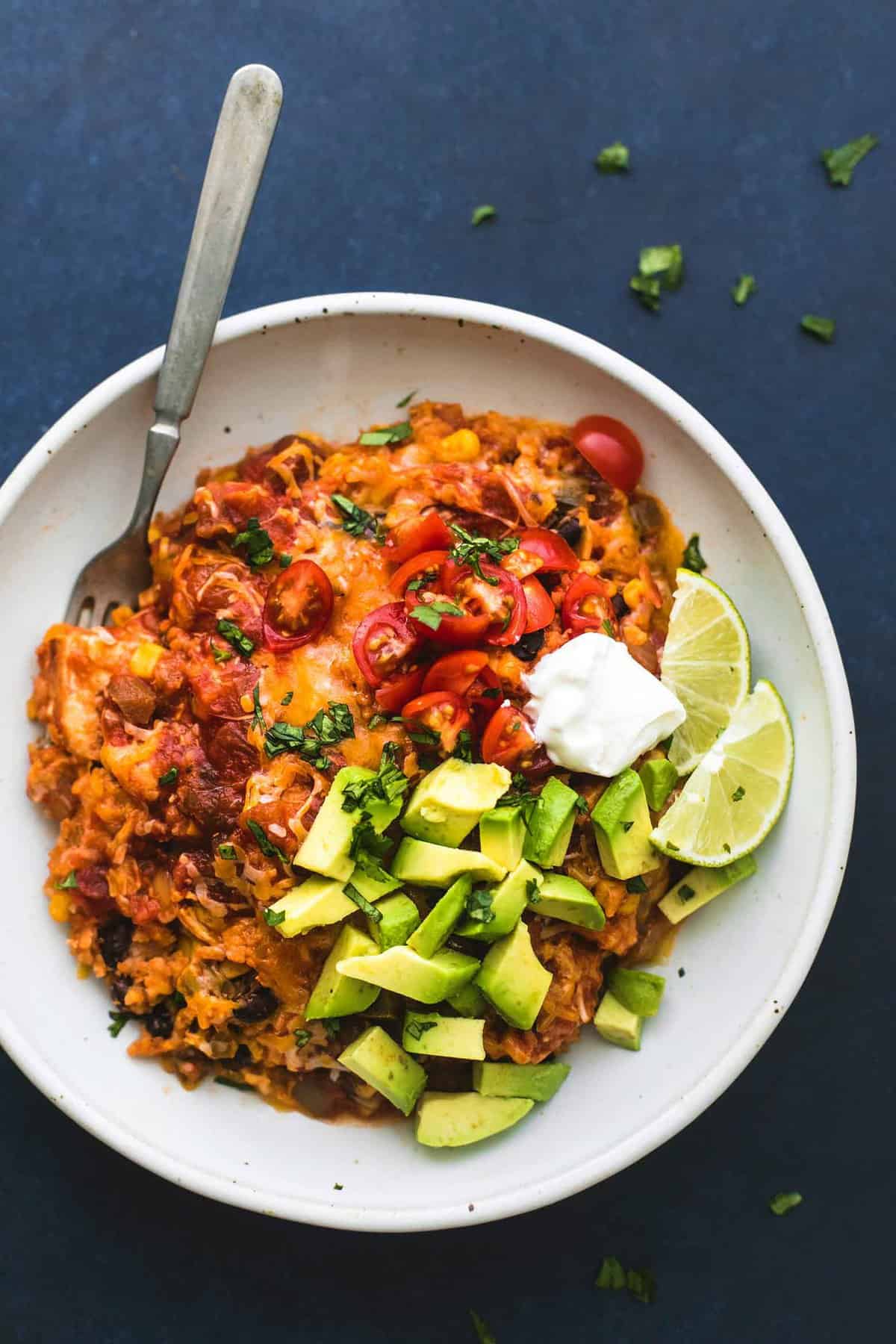 top view of instant pot cheesy Mexican chicken and rice with a fork in a bowl.
