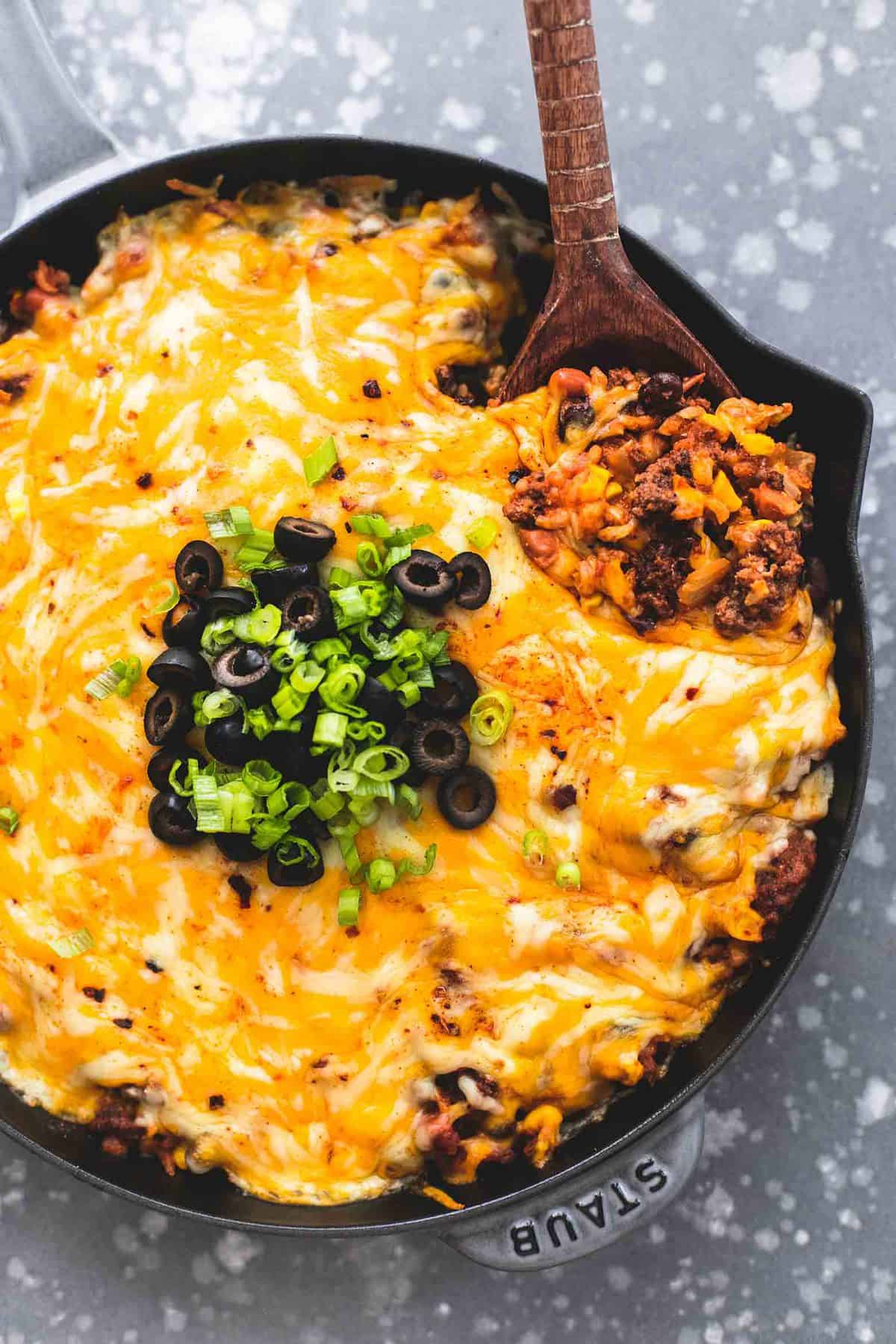 top view of Mexican beef and rice skillet with a wooden serving spoon in a skillet.