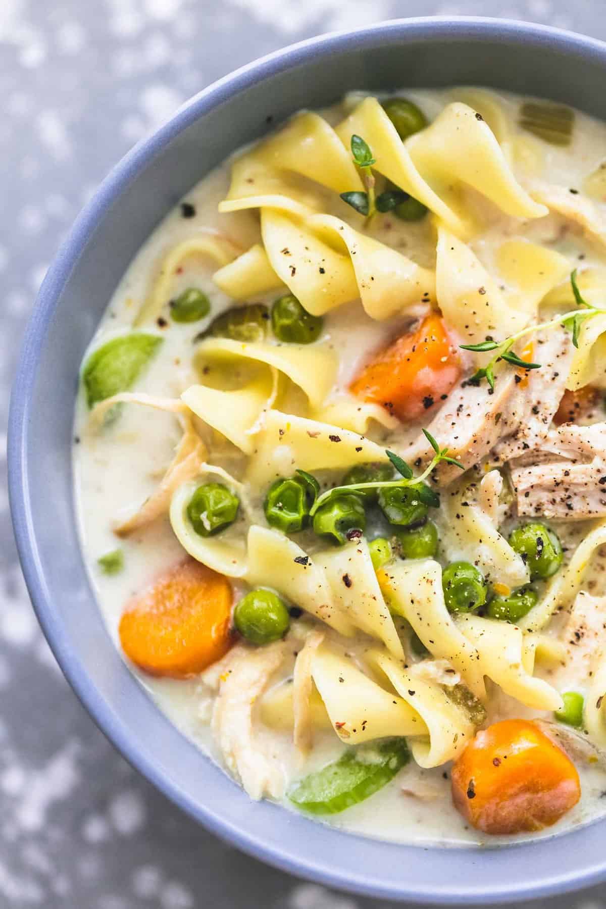 close up top view of creamy chicken noodle soup in a bowl.