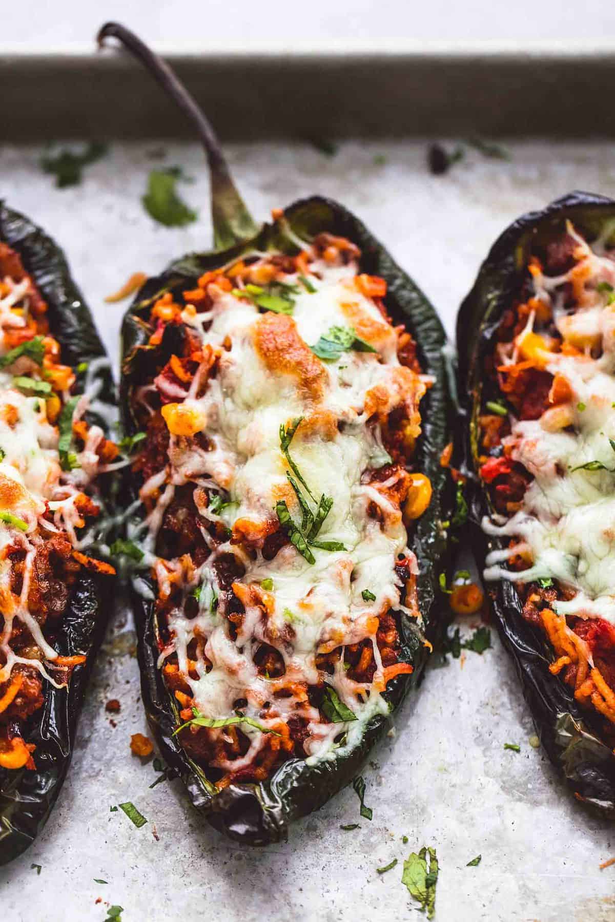 close up of Southwest stuffed poblano peppers on a baking sheet.