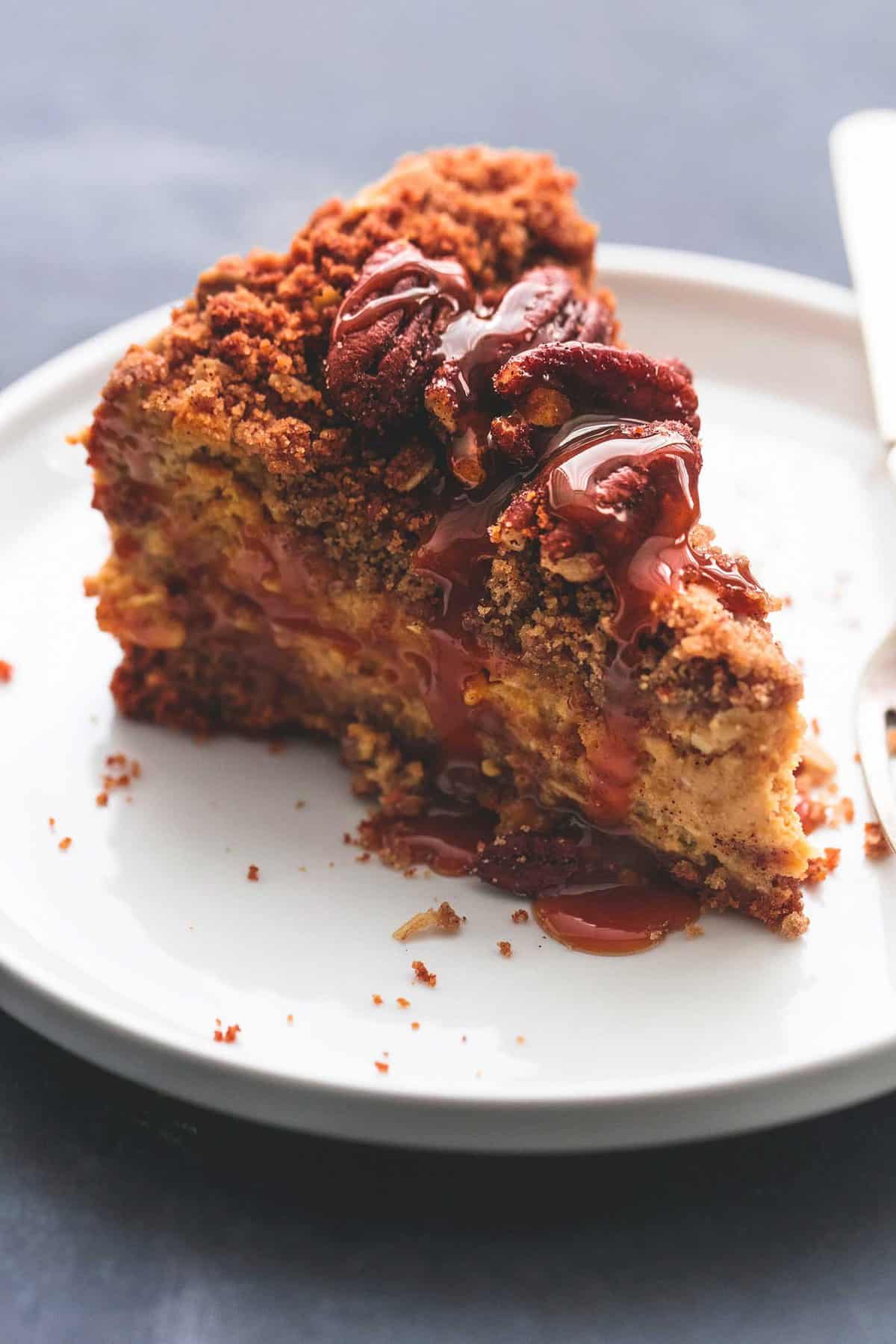 a slice of caramel pecan pumpkin cheesecake on a plate.