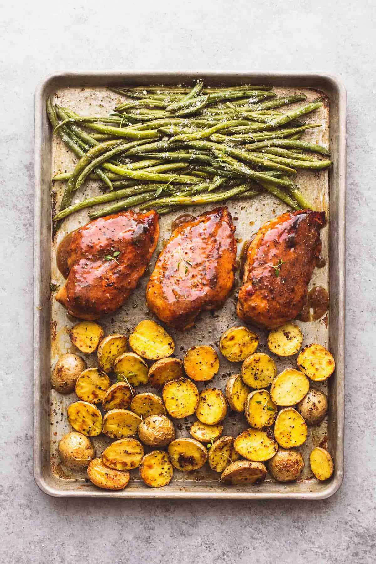 top view of sheet pan chicken potatoes and green beans on a sheet pan.