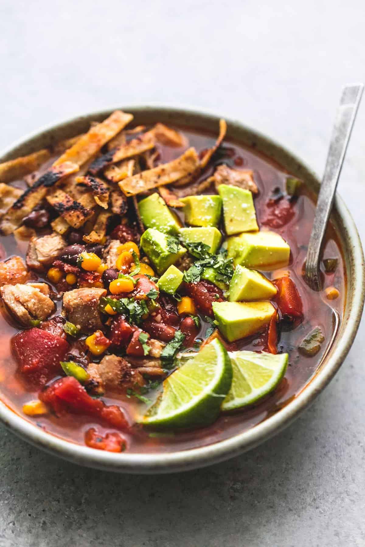 Mexican chicken tortilla soup with a spoon in a bowl.