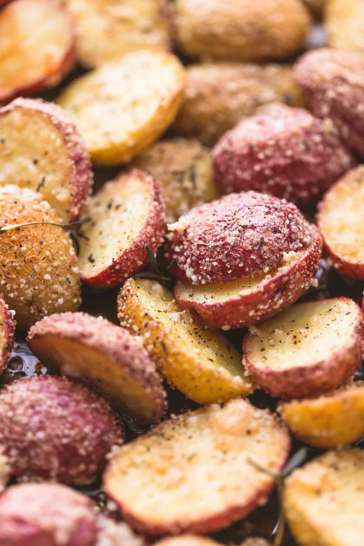 close up of sliced potatoes baked and topped with a seasoning coating.