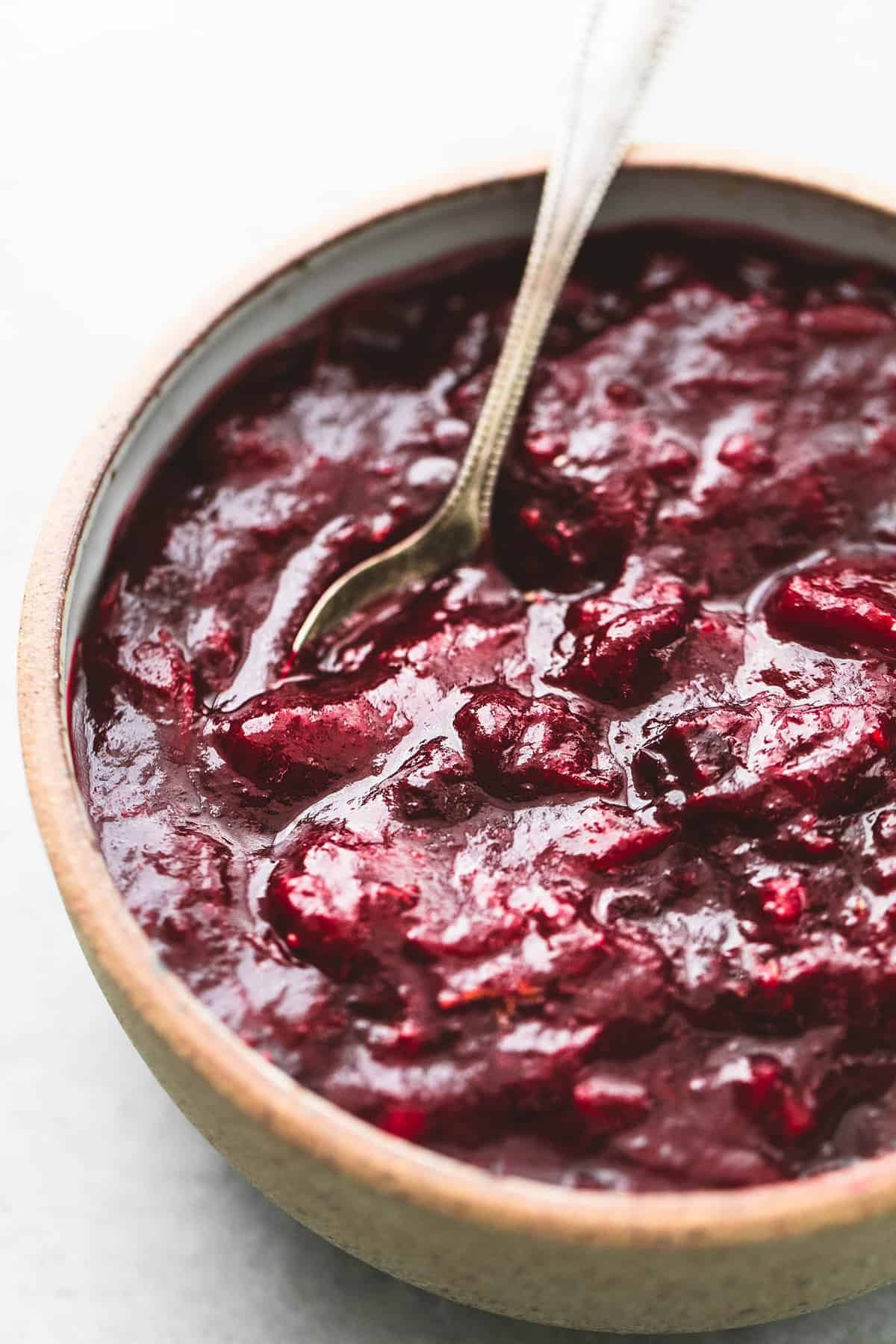 cranberry sauce with a spoon in a bowl.