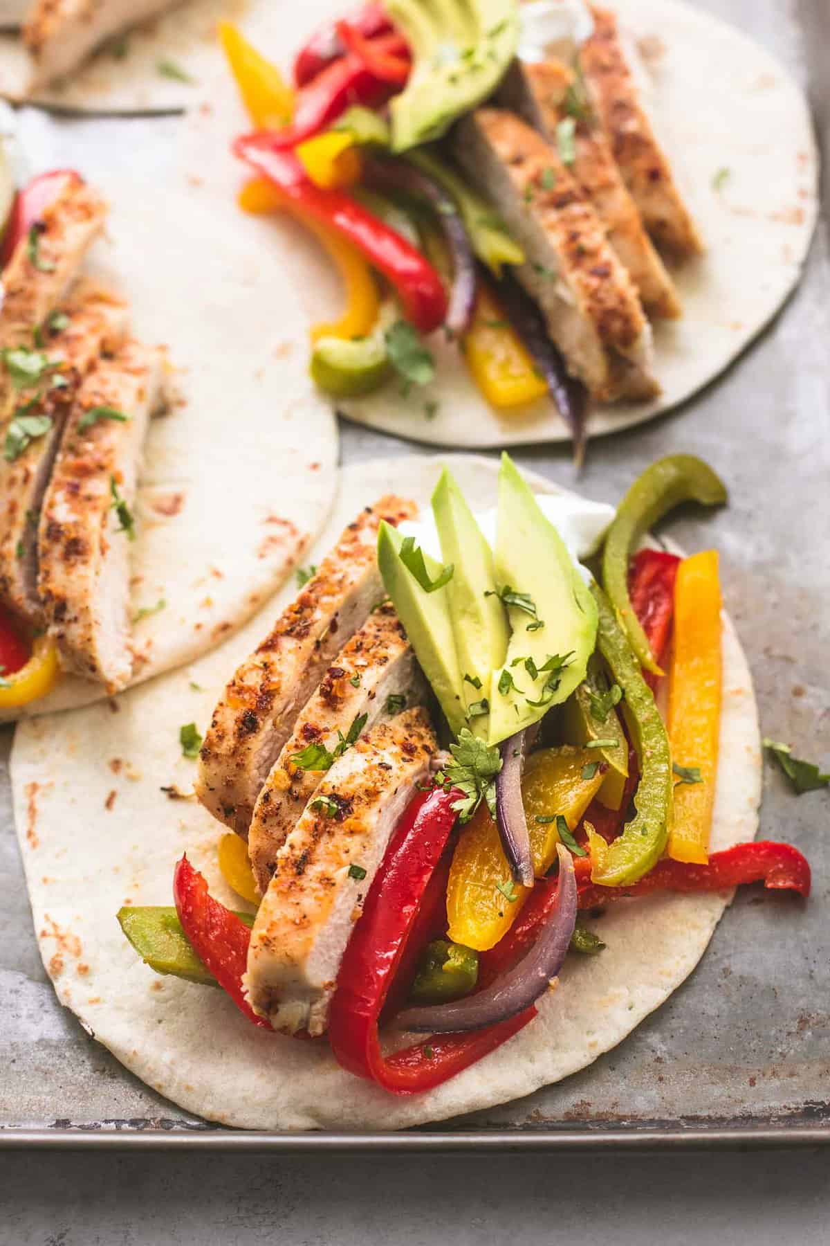 close up of sheet pan chicken fajitas on a sheet pan.