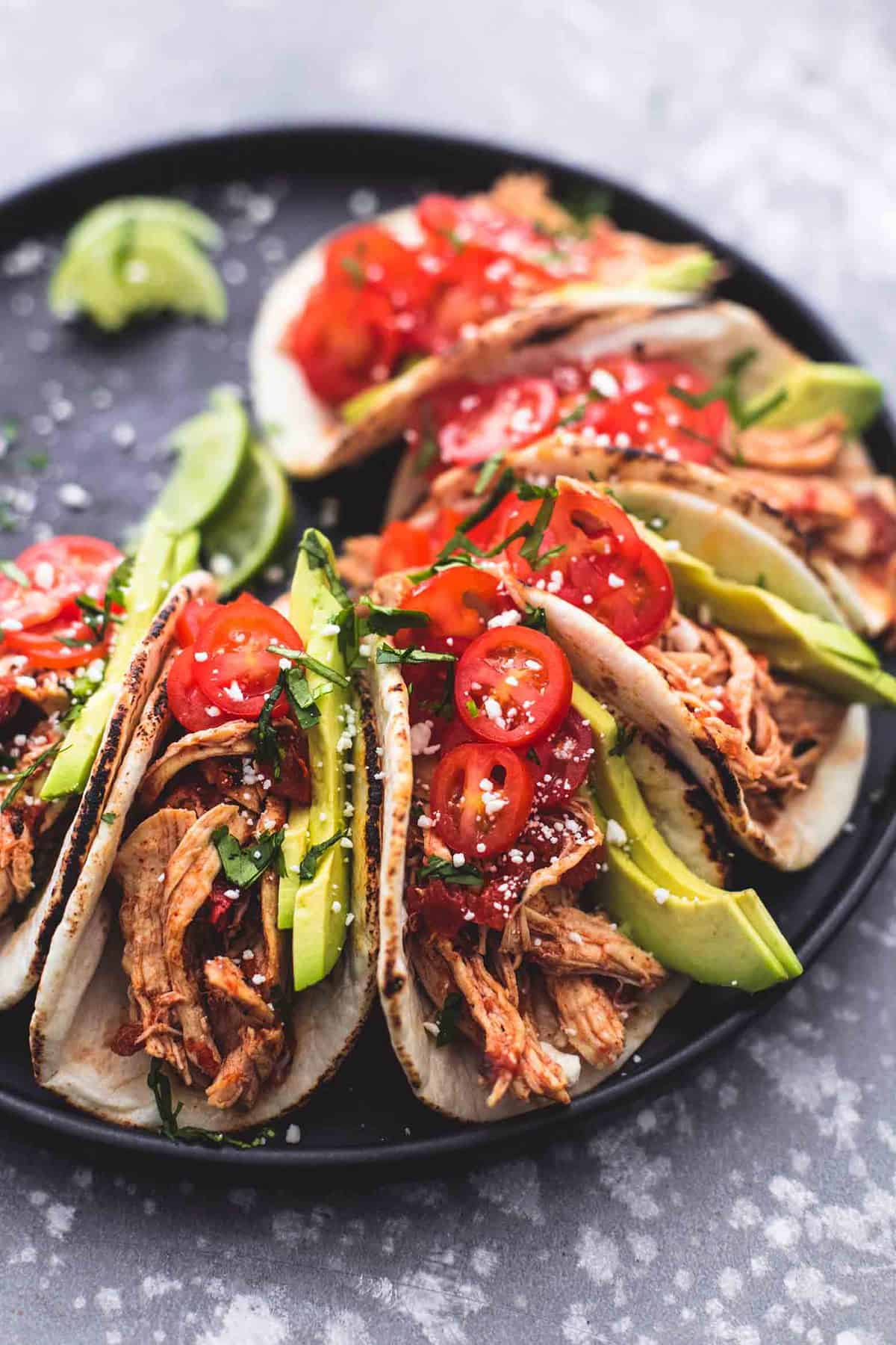 instant pot shredded chicken tacos on a round platter.