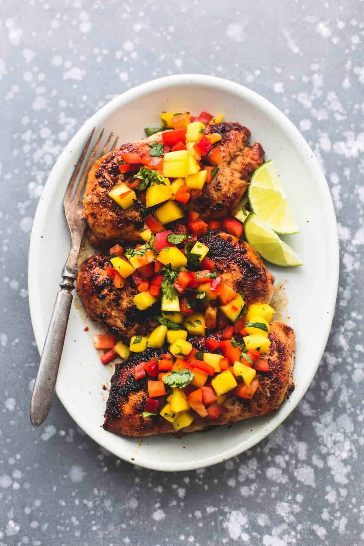 Easy, healthy and flavorful with just a few simple ingredients, this Mango Salsa Chicken will be your go-to for busy nights! | lecremedelacrumb.com