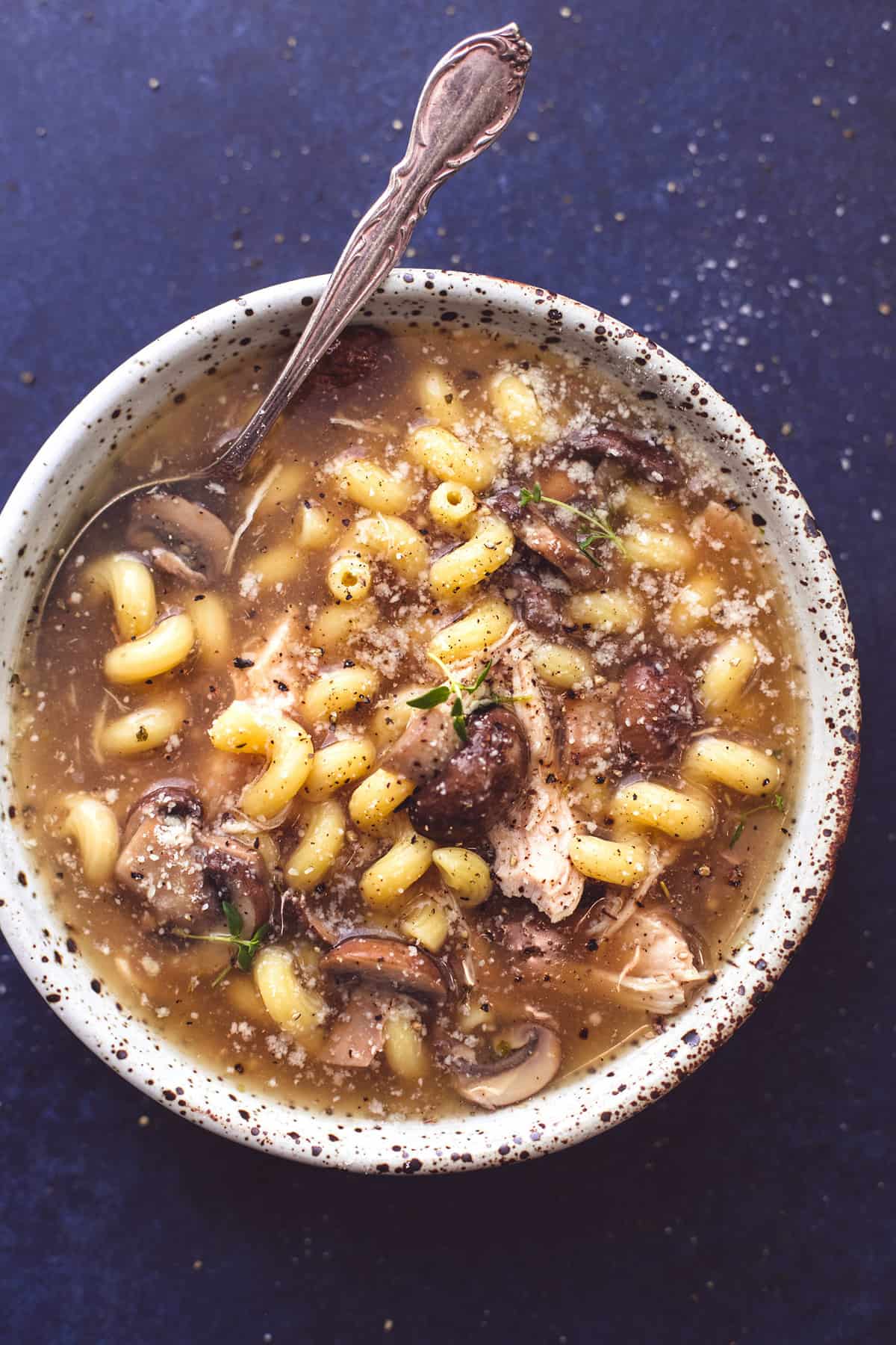 top view of chicken marsala soup with a spoon in a bowl.