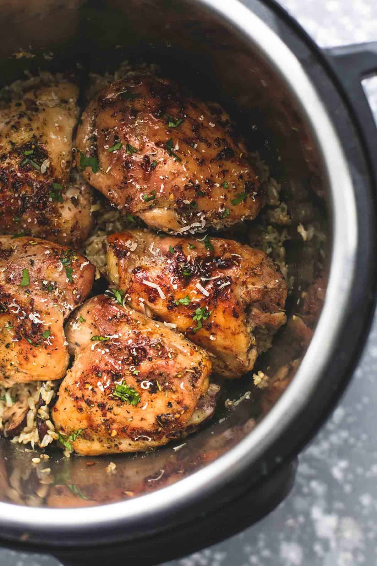 close up top view of instant pot parmesan chicken and mushroom rice in an instant pot.