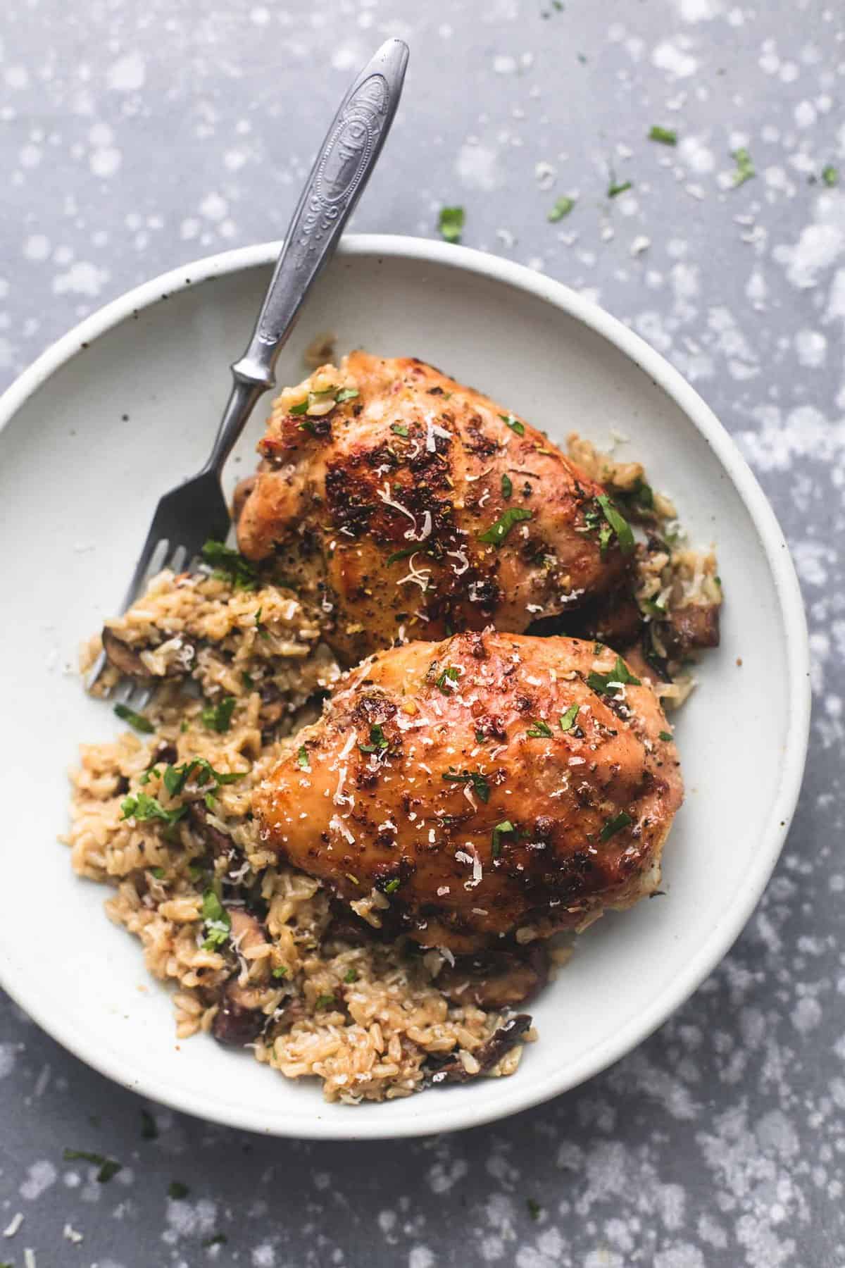 top view of instant pot parmesan chicken and mushroom rice with a fork on a plate.